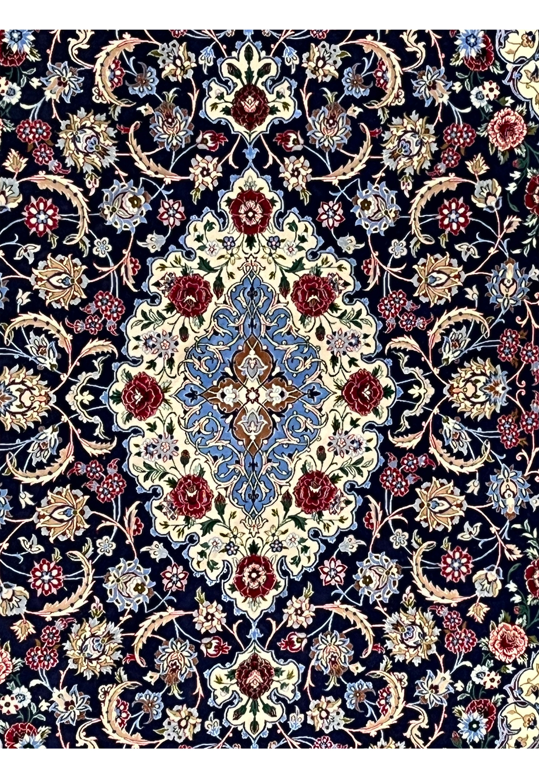 Close up of Isfahan rug medallion showing silk highlights, ivory and light blue detailing, and extremely fine hand knotted construction