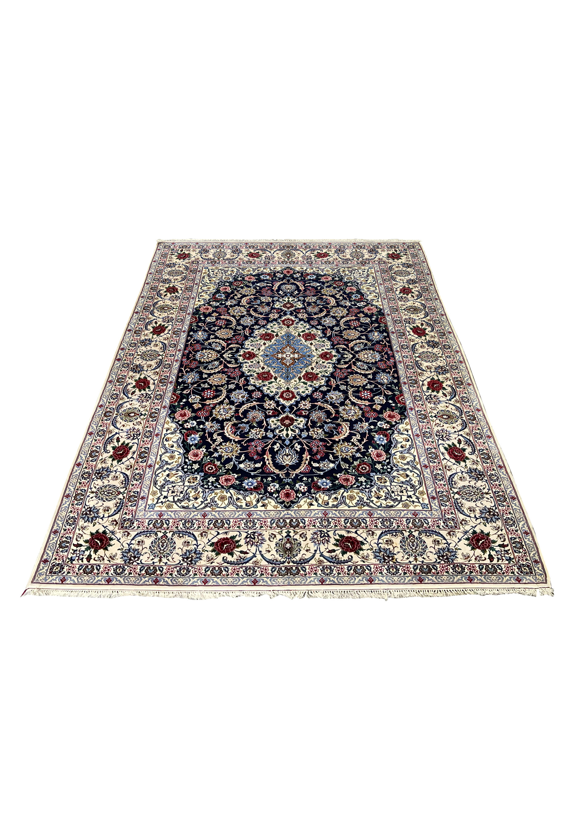 Laid down view of a 7 x 10 Persian Isfahan wool and silk rug showing balanced floral composition, navy background, ivory borders, and refined symmetry