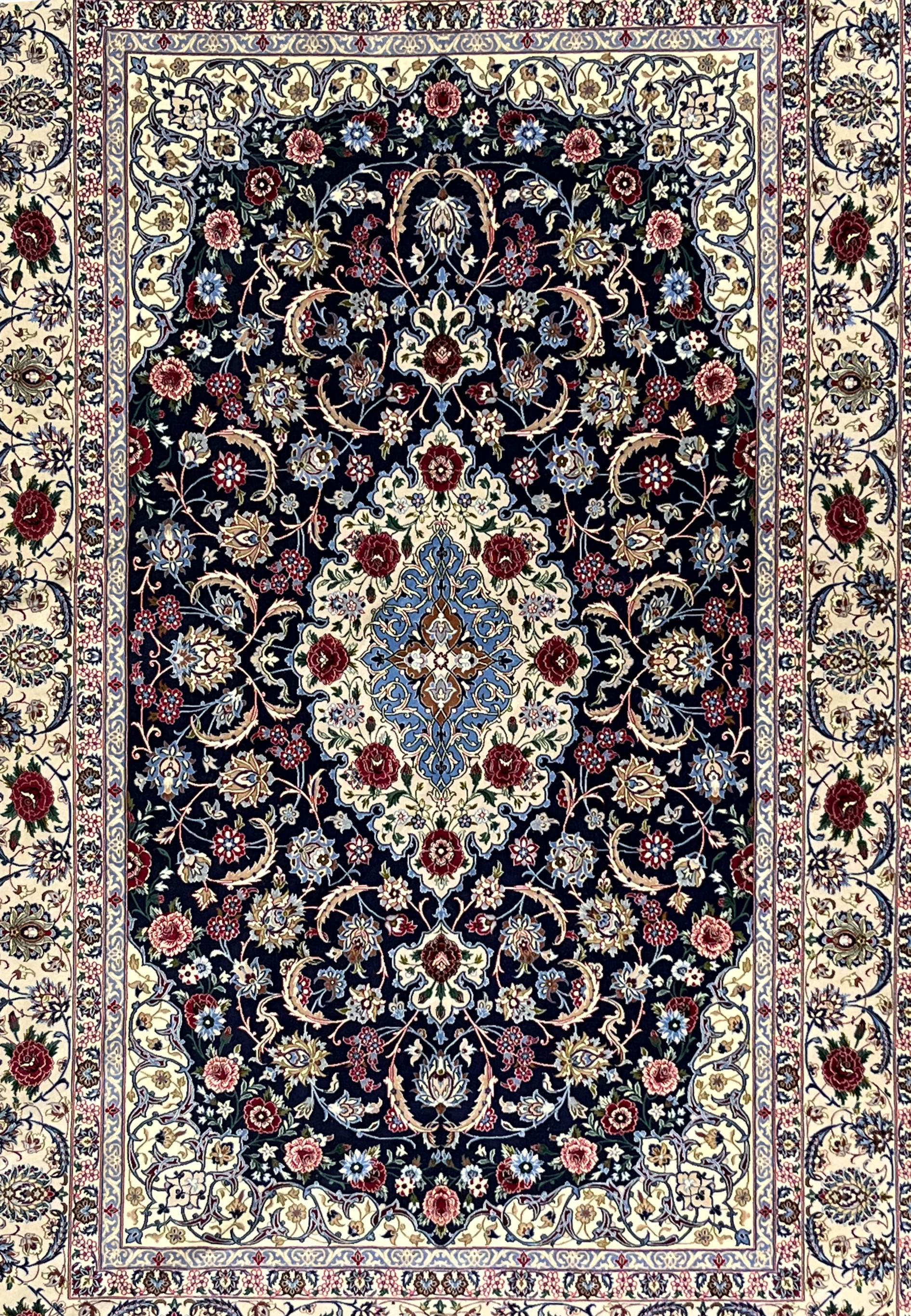 Midfield detail of super fine Persian Isfahan rug highlighting navy ground, scrolling floral vines, silk highlights, and precise hand knotted detailing