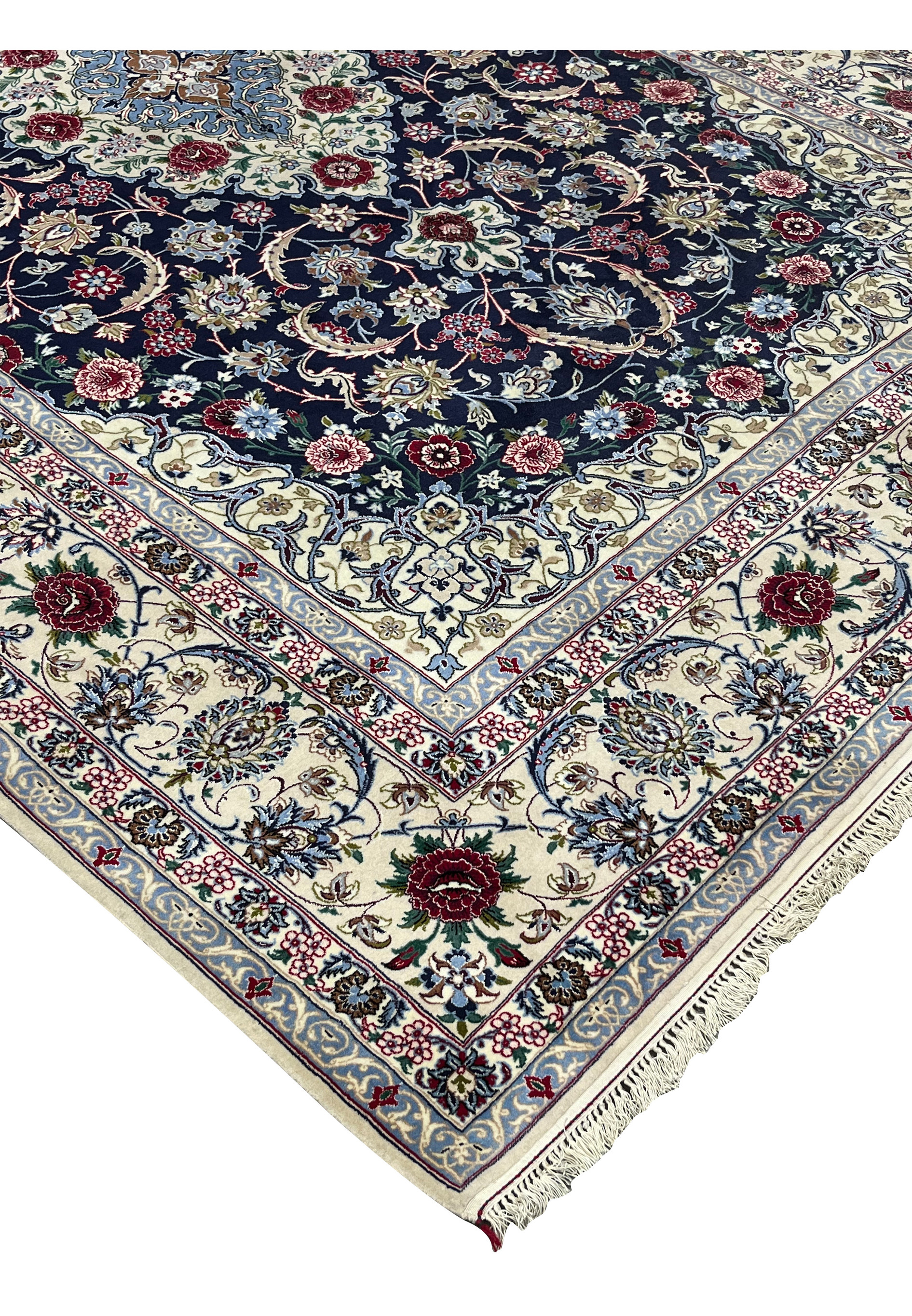 Side edge view of a Persian Isfahan rug showing clean selvedge, tight knot structure, and rich navy, ivory, and burgundy color palette