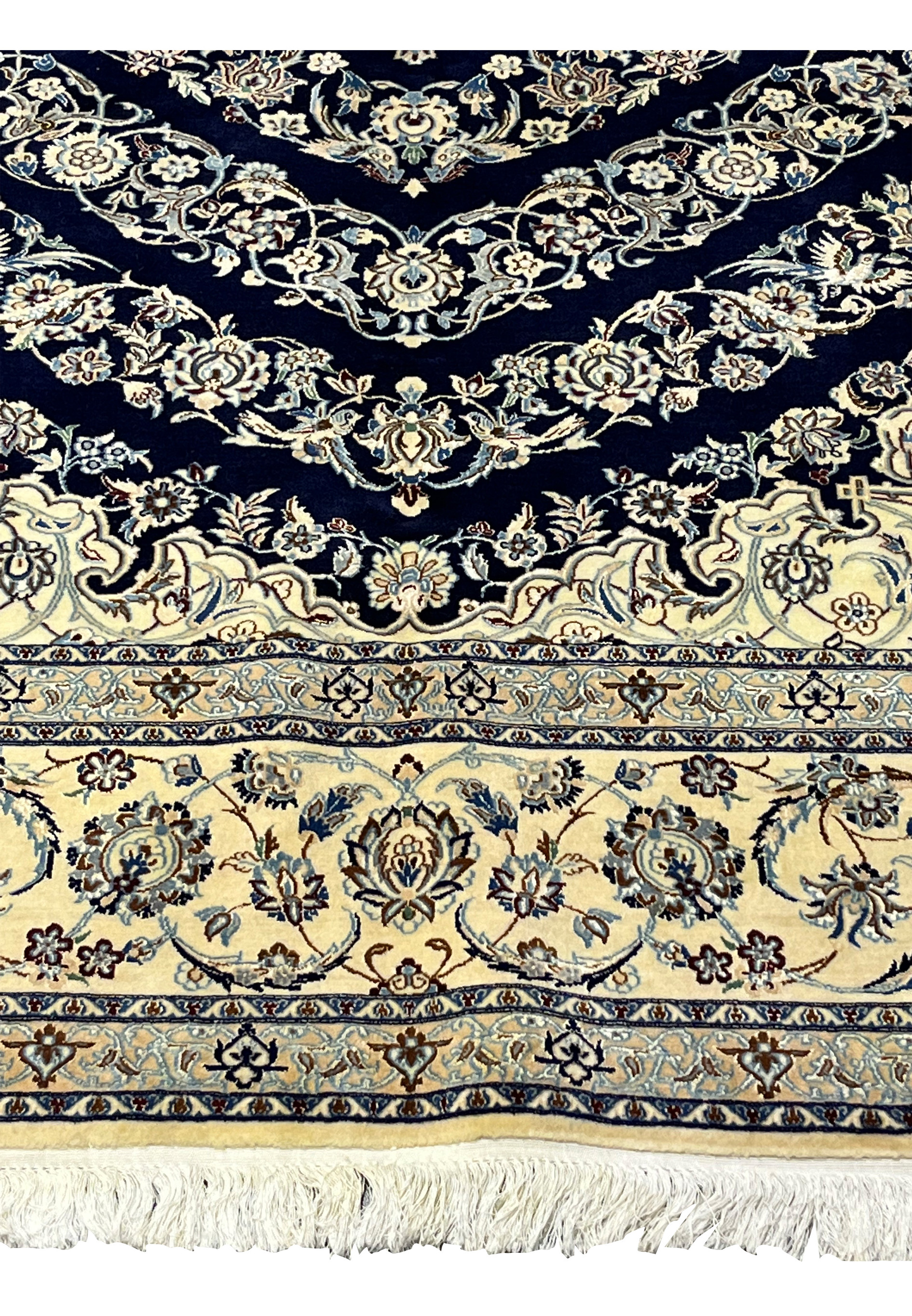 Lower border of a Persian Nain 6 La rug featuring ivory ground with floral arabesques and precise silk detailing