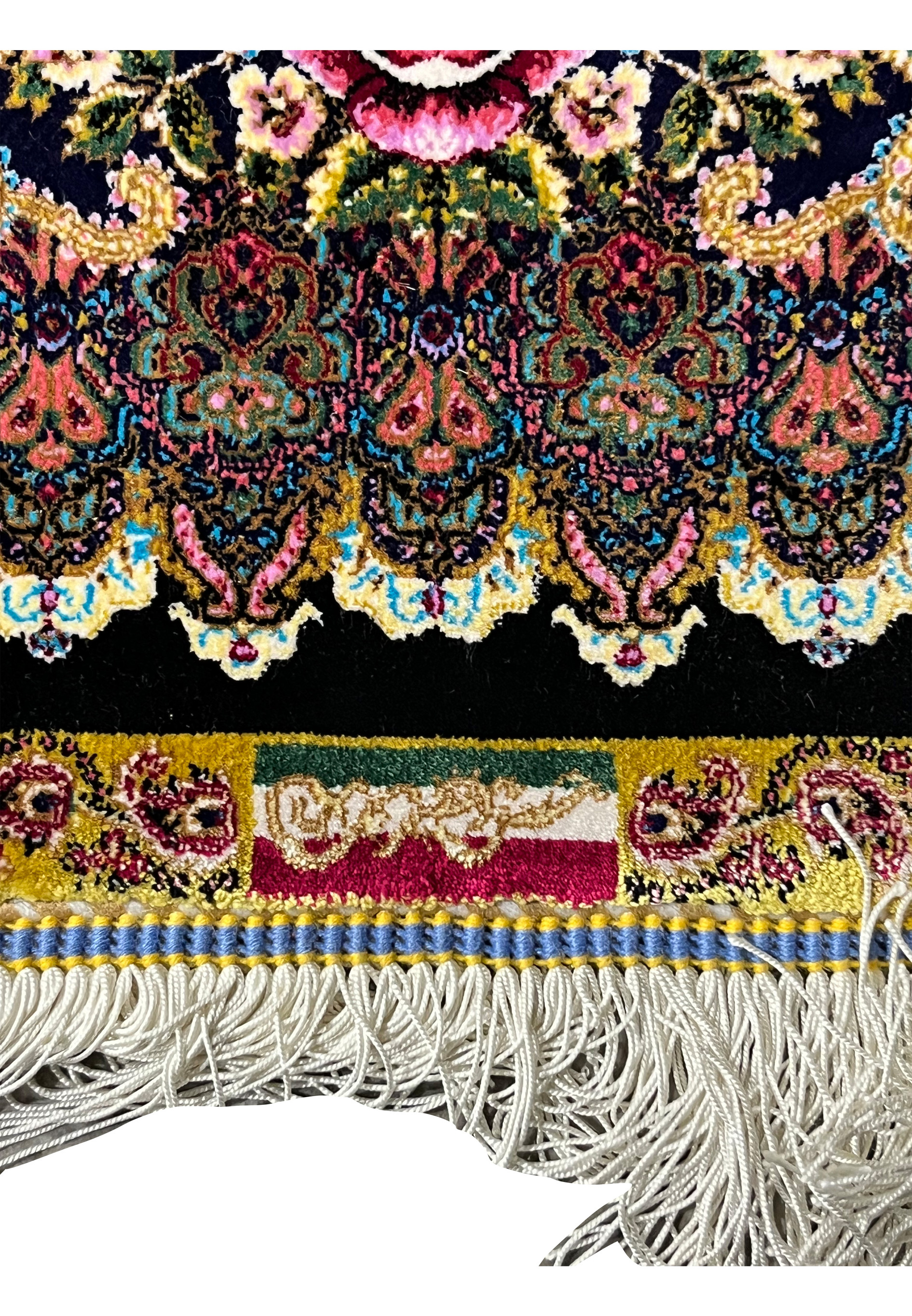 Woven signature detail on a signed Persian Qum pure silk rug confirming workshop authenticity