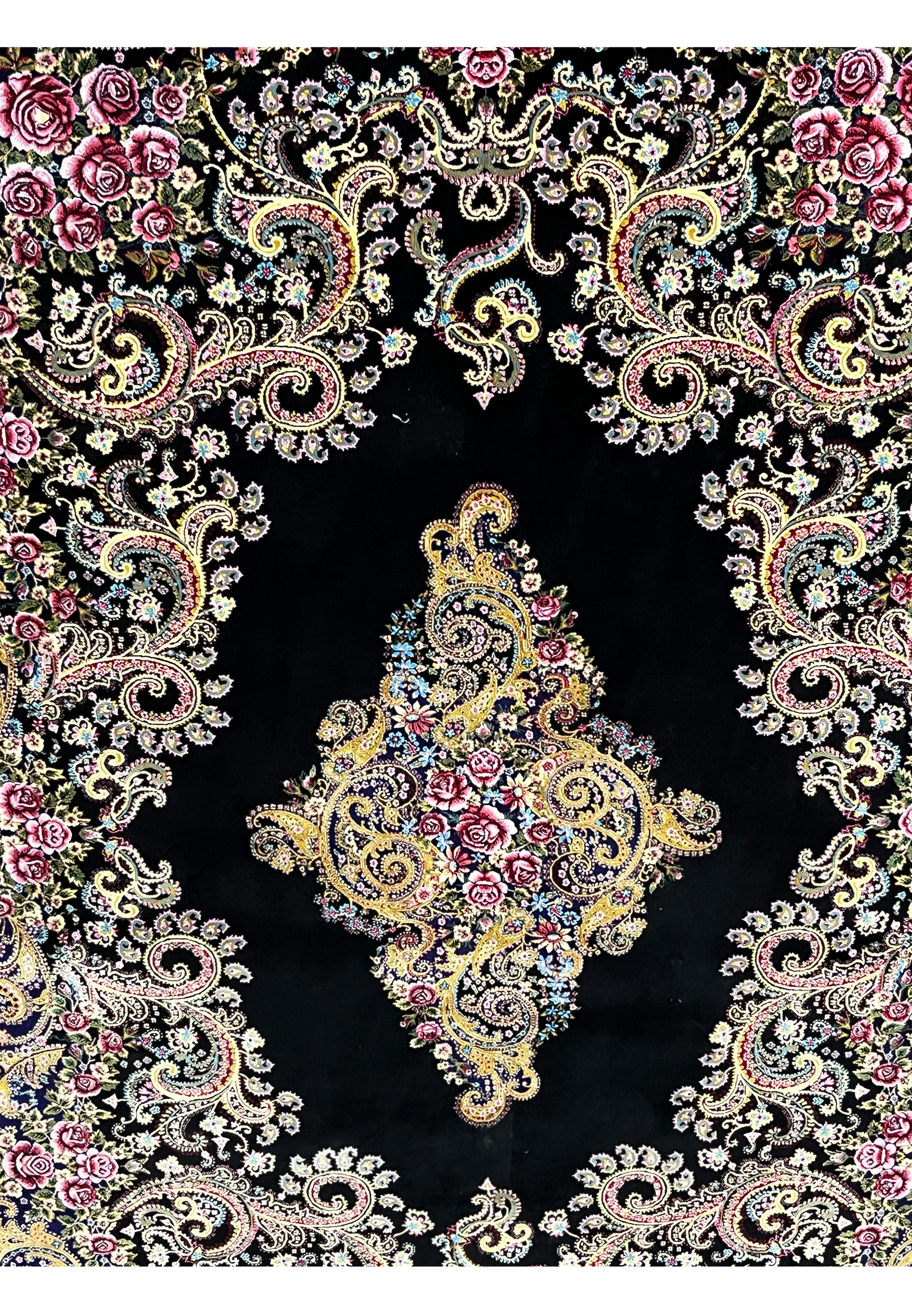 Close-up of the central medallion on a signed Persian Qum silk rug with gold scrollwork and rose floral details