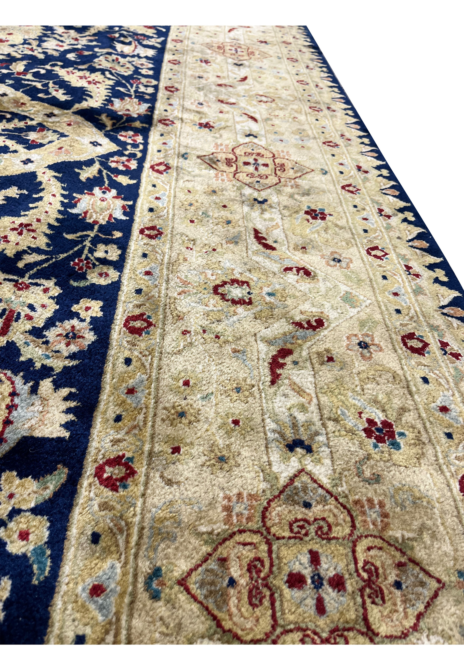 Border close-up highlighting the craftsmanship of a used Agra rug with floral medallions, antique gold tones, light abrasion, and repaired edges