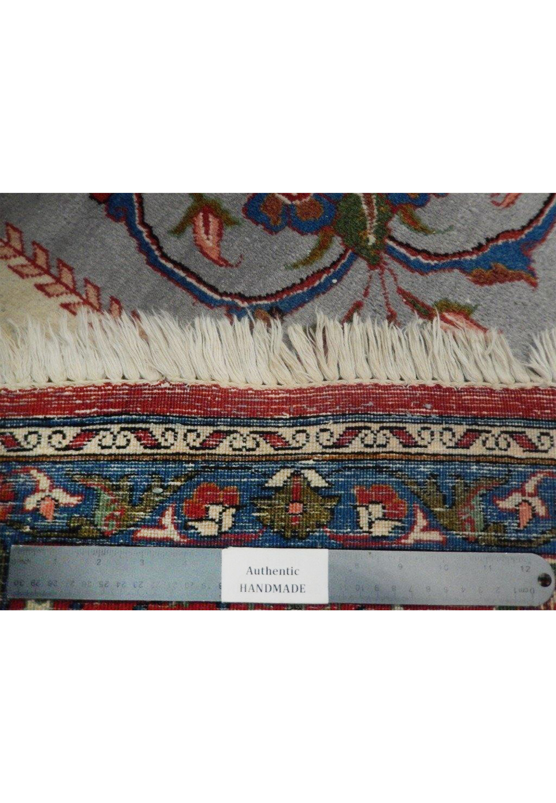 Fringe and lower border detail of a hand-knotted Persian Isfahan rug showing backside, tight knot structure, and clean edge finish