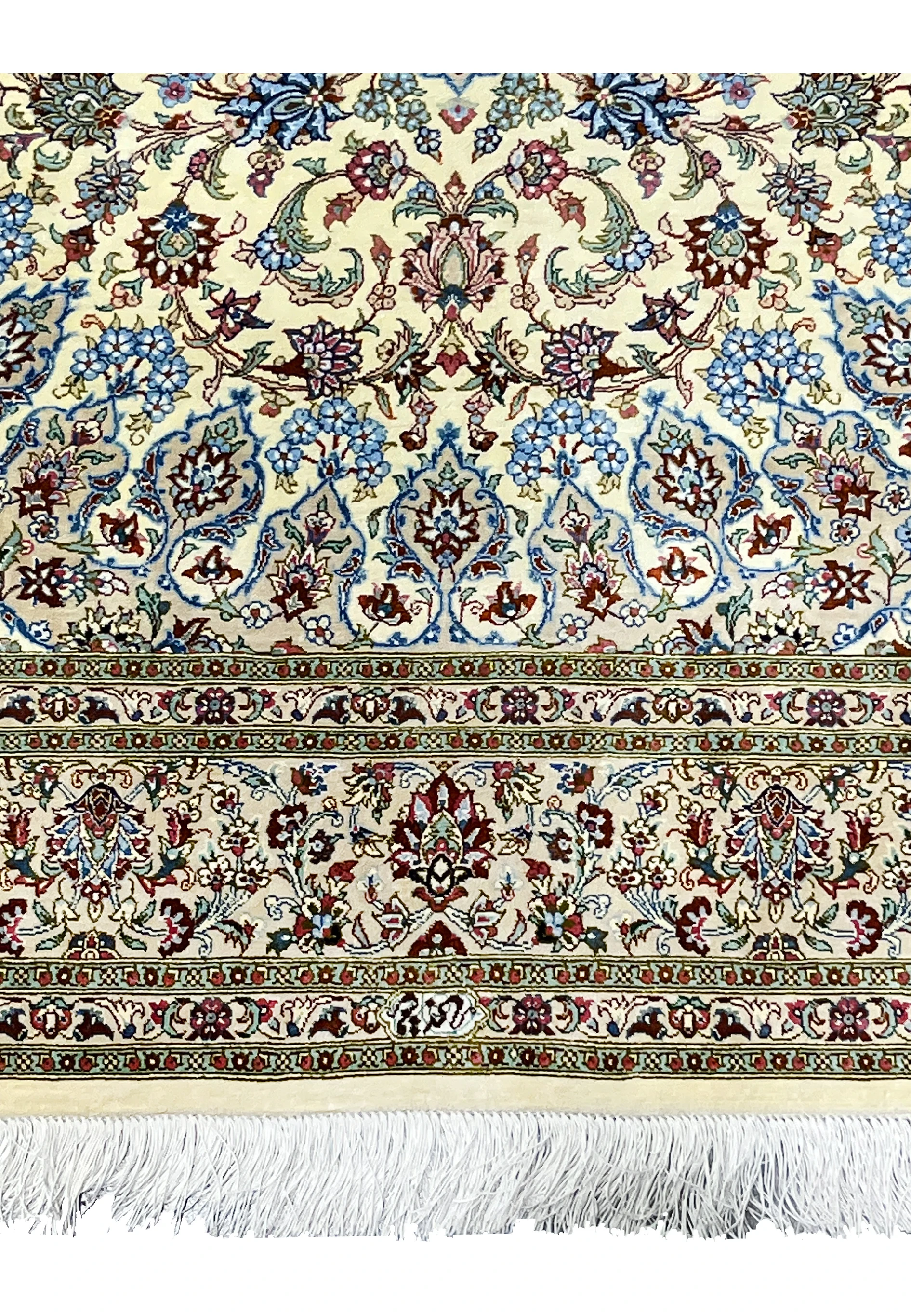 Lower border detail of a 4'5 x 6'7 signed Persian Qum silk rug displaying intricate floral bands, balanced spacing, and clean silk fringe finish.