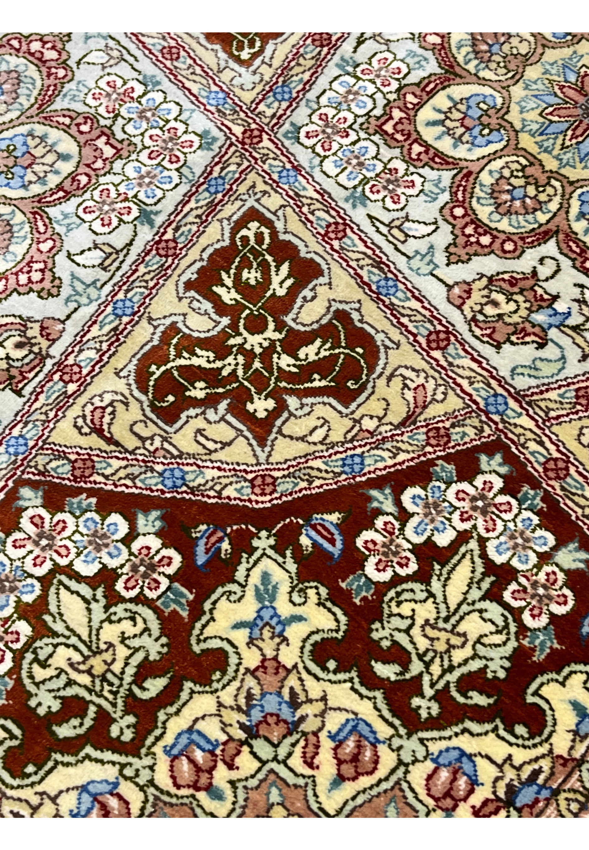 Pattern and motif detail of signed Amjadi Persian Qum silk rug showing floral rosettes, geometric panels, and balanced color harmony