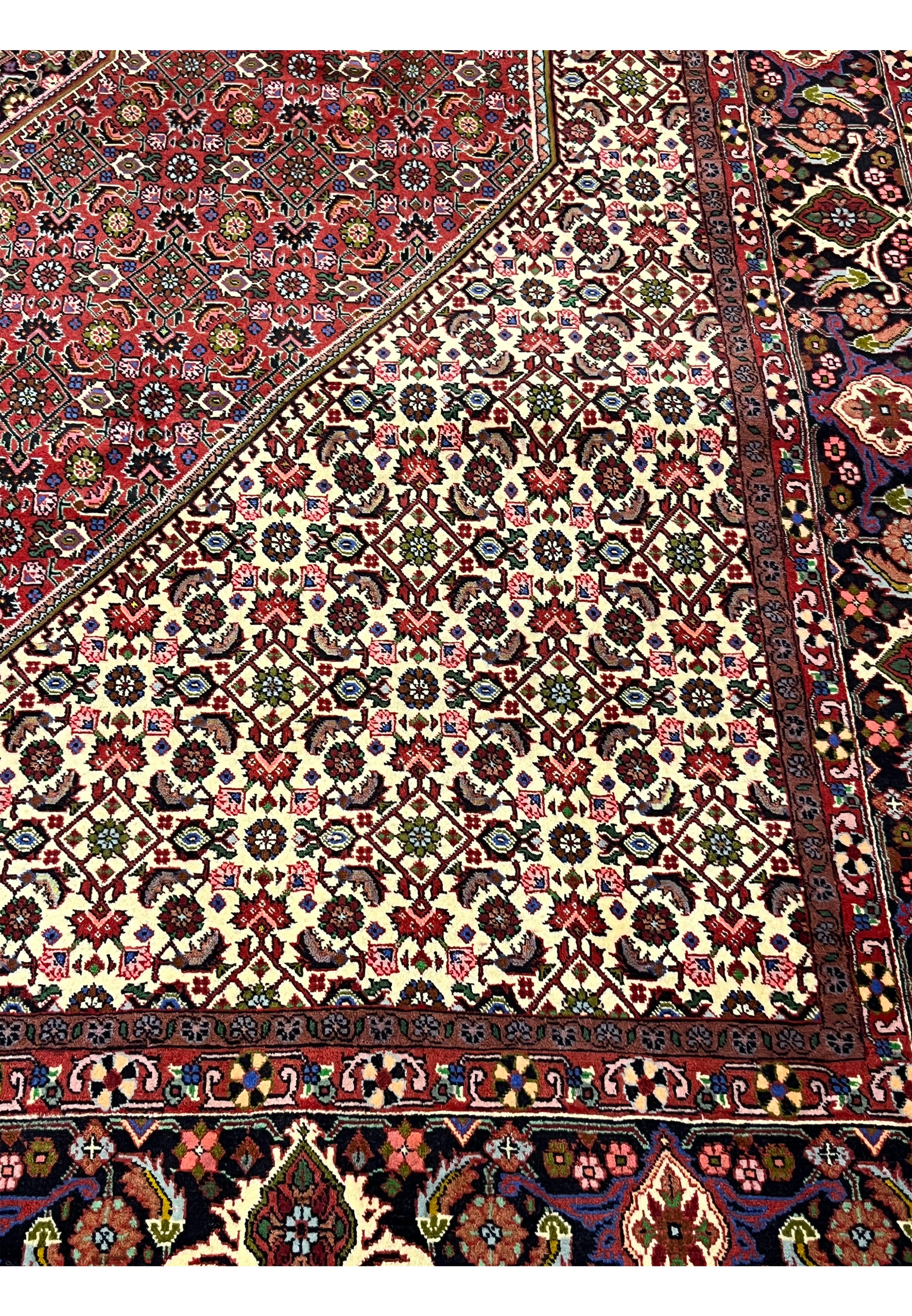 Inner border detail of Persian Bijar rug showing precise geometric framing, soft beige transitions, and structured pattern definition