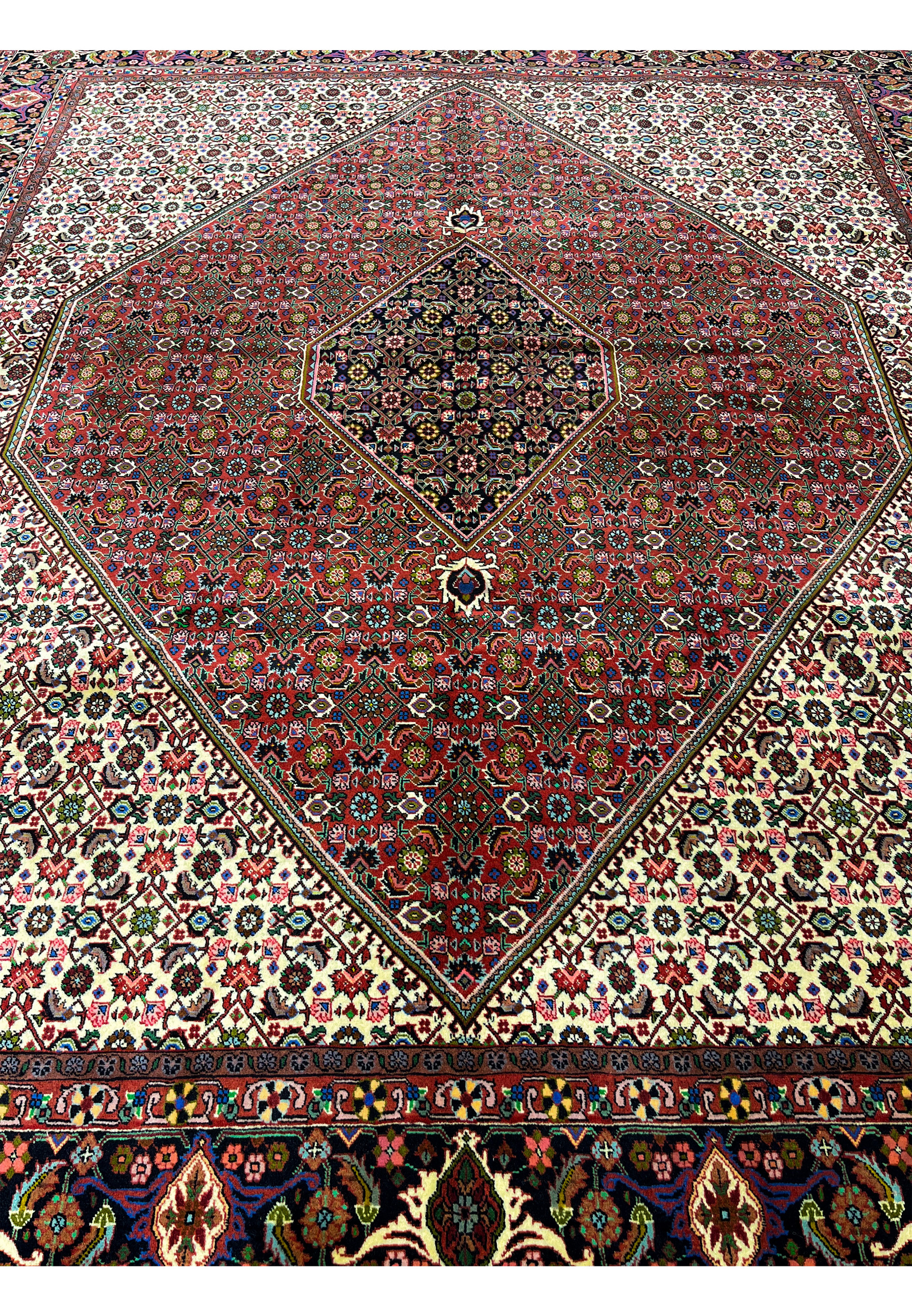 Laid down view of Persian Bijar rug illustrating overall proportions, strong medallion presence, ivory background, and balanced composition