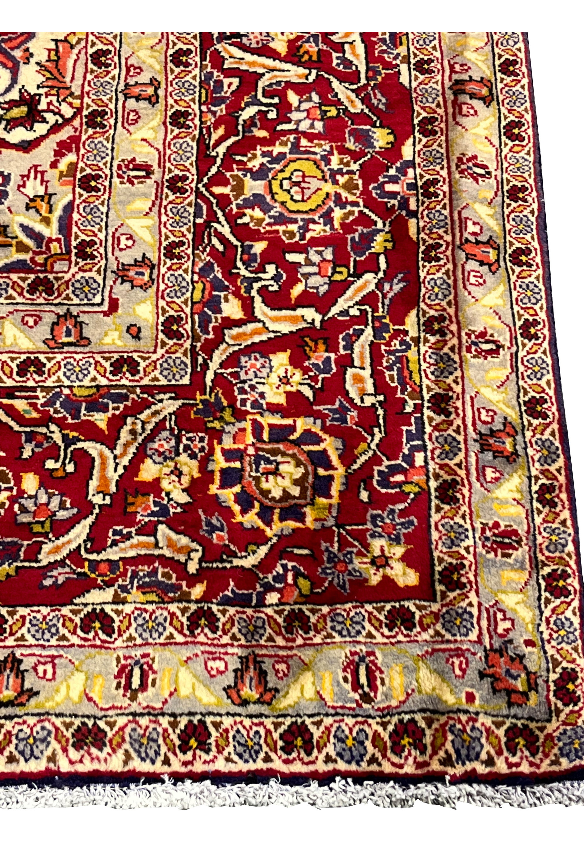 Full border view of Persian Isfahan rug showing layered floral borders, ivory ground, brick red accents, and finely drawn vine motifs
