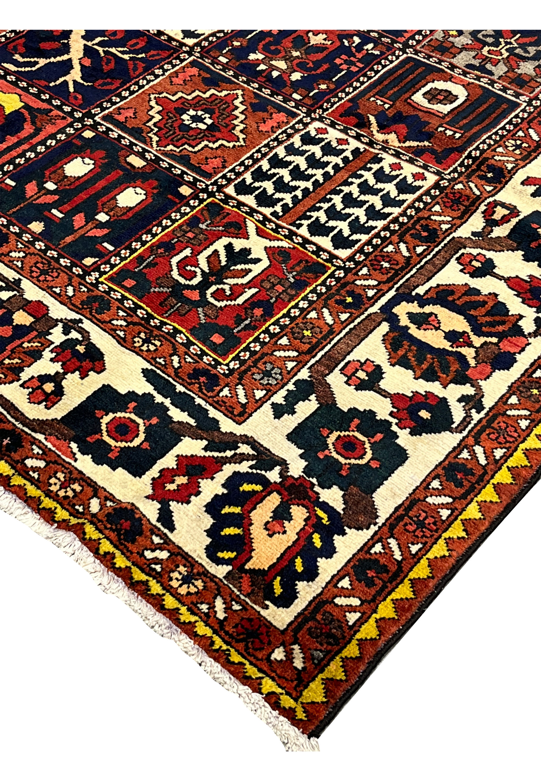 Close view of the rug edge on a Persian Bakhtiar garden rug displaying clean finishing, dense wool pile, and traditional craftsmanship along the border