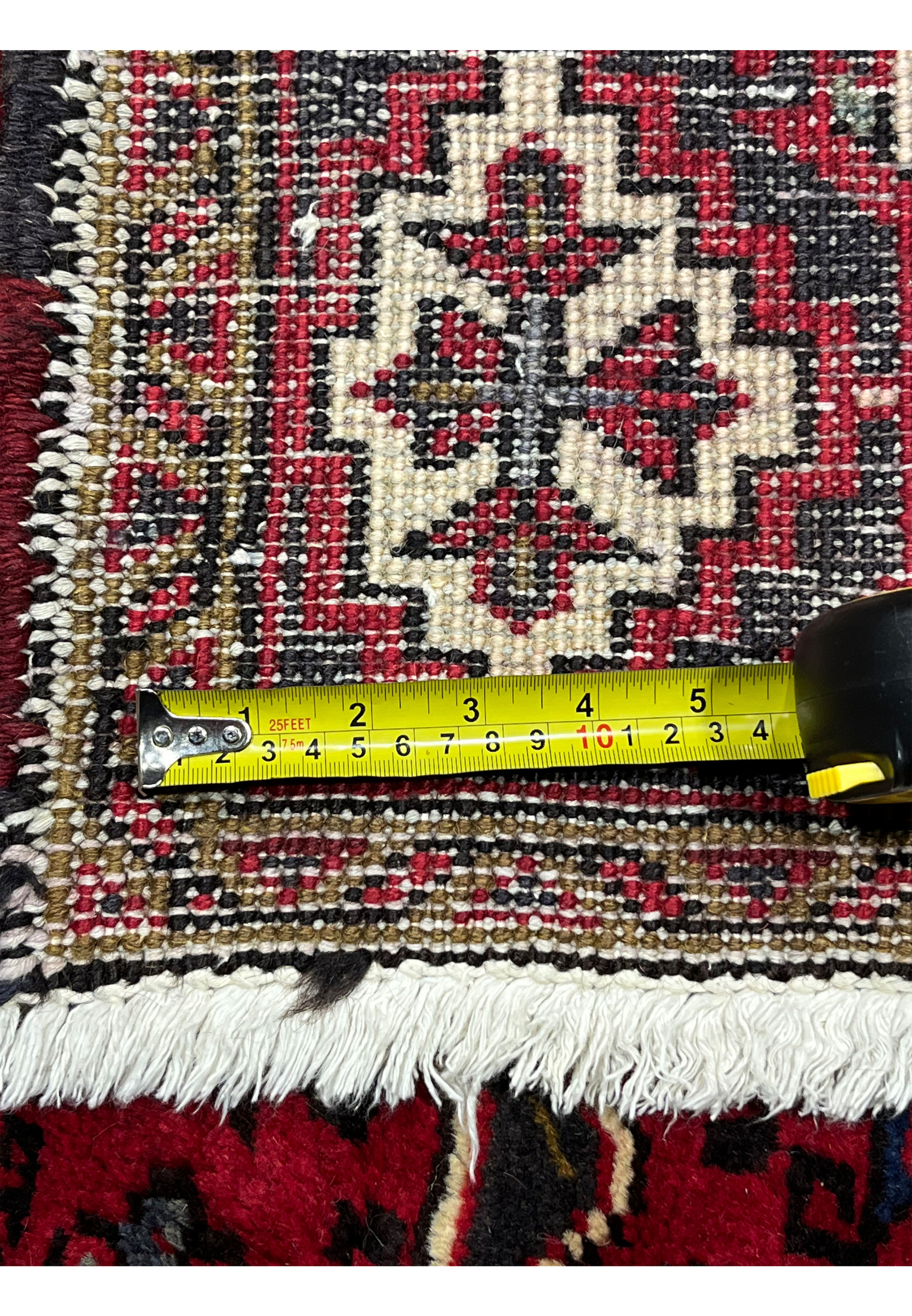 Backside with measuring tape across knots to show pile density and construction quality of 6'4 x 10'1 Persian Heriz hand knotted wool tribal rug
