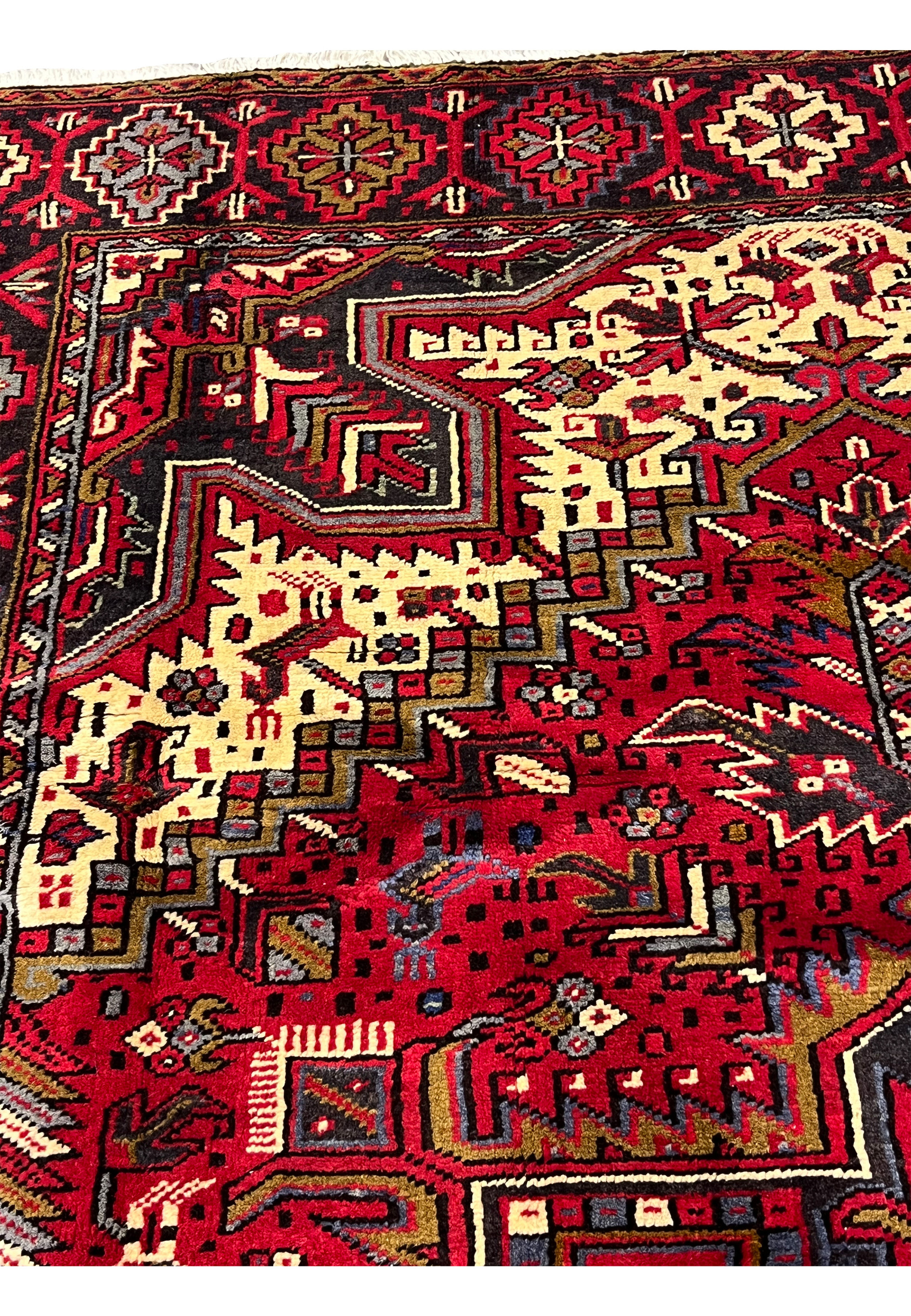 Inner guard border closeup featuring stepped geometric lines, small tribal elements and tight knot structure typical of authentic Persian Heriz rugs
