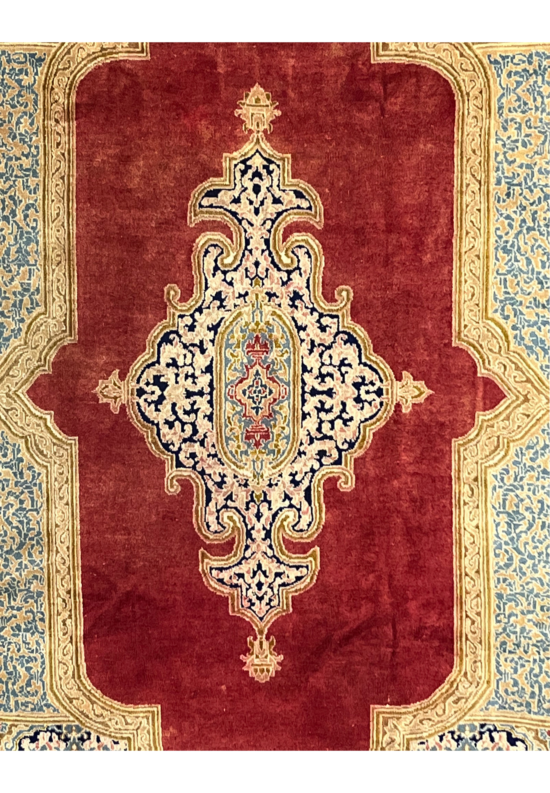 Center medallion detail Persian Kerman rug ivory and navy floral scrollwork on brick red background intricate hand knotted design