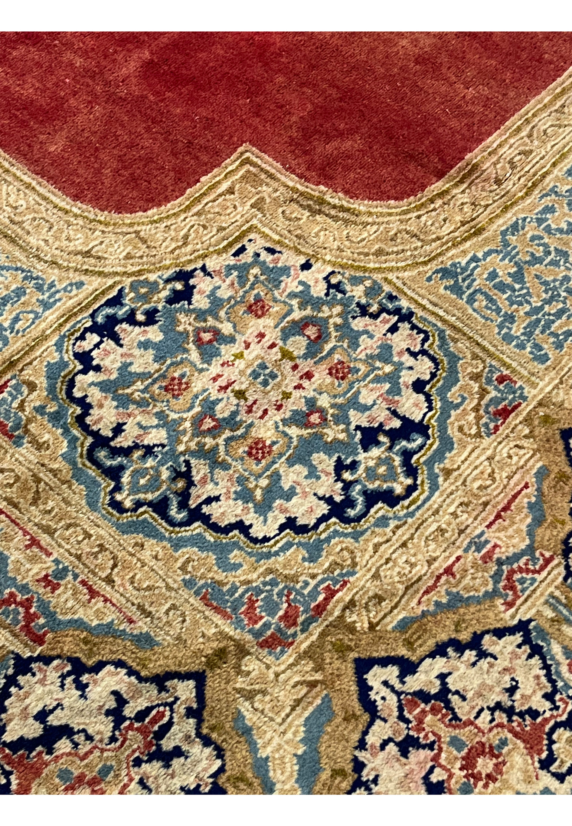 Floral motif closeup Persian Kerman rug scrolling vines blossoms ivory navy sky blue tones soft aged wool texture