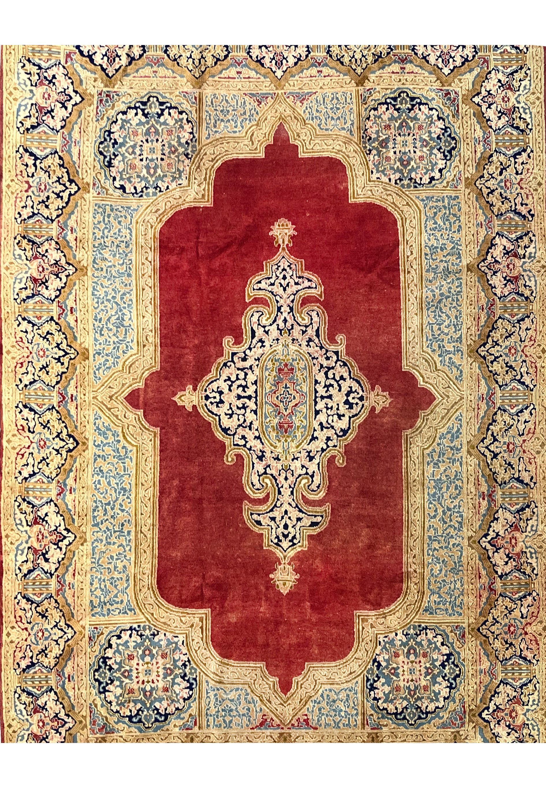 Antique Persian Kerman rug midfield close view brick red field ivory floral medallion navy vines hand knotted wool distressed patina