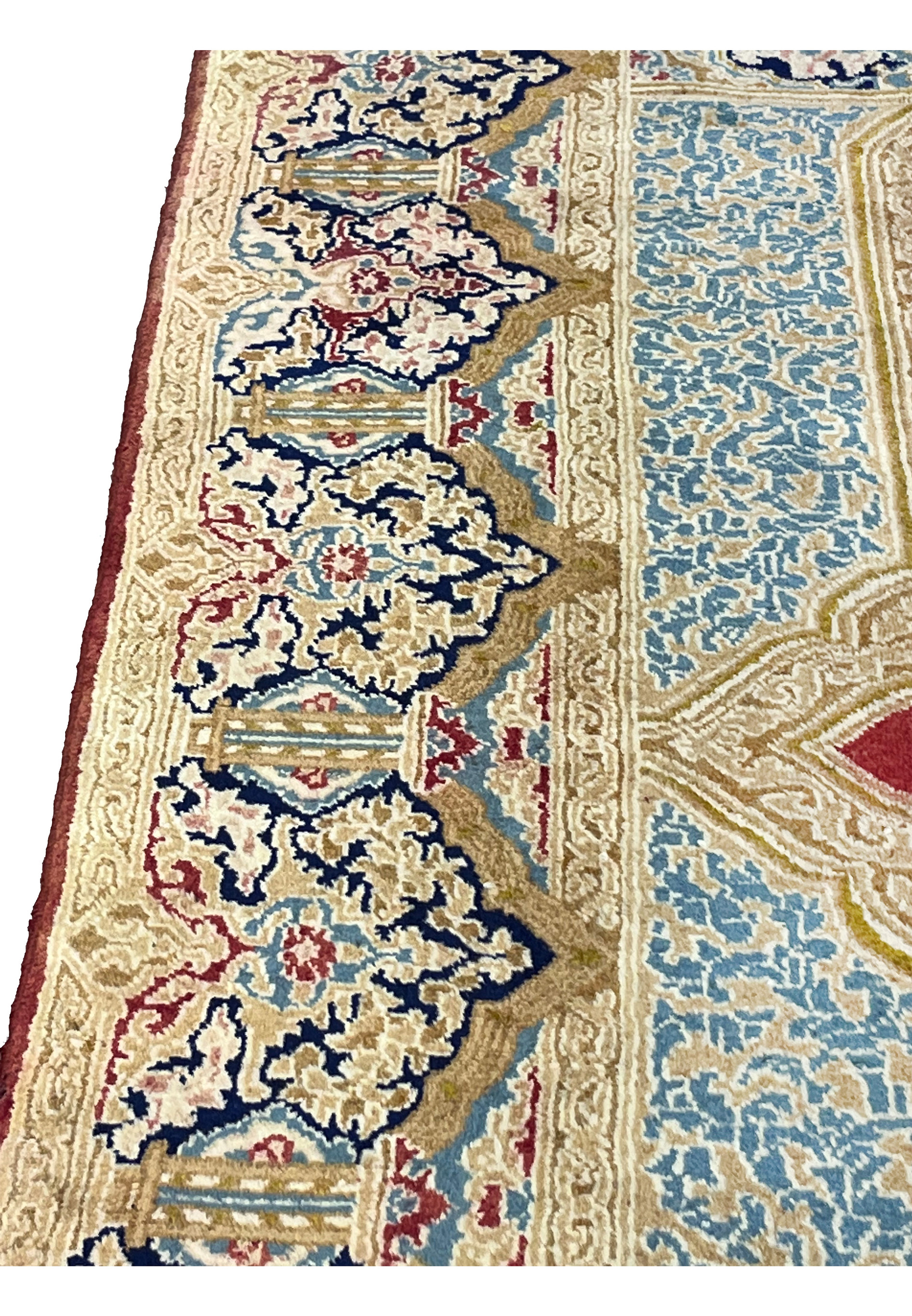 Edge detail of Kerman rug highlighting ivory guard borders, floral vines and clean hand bound selvage construction