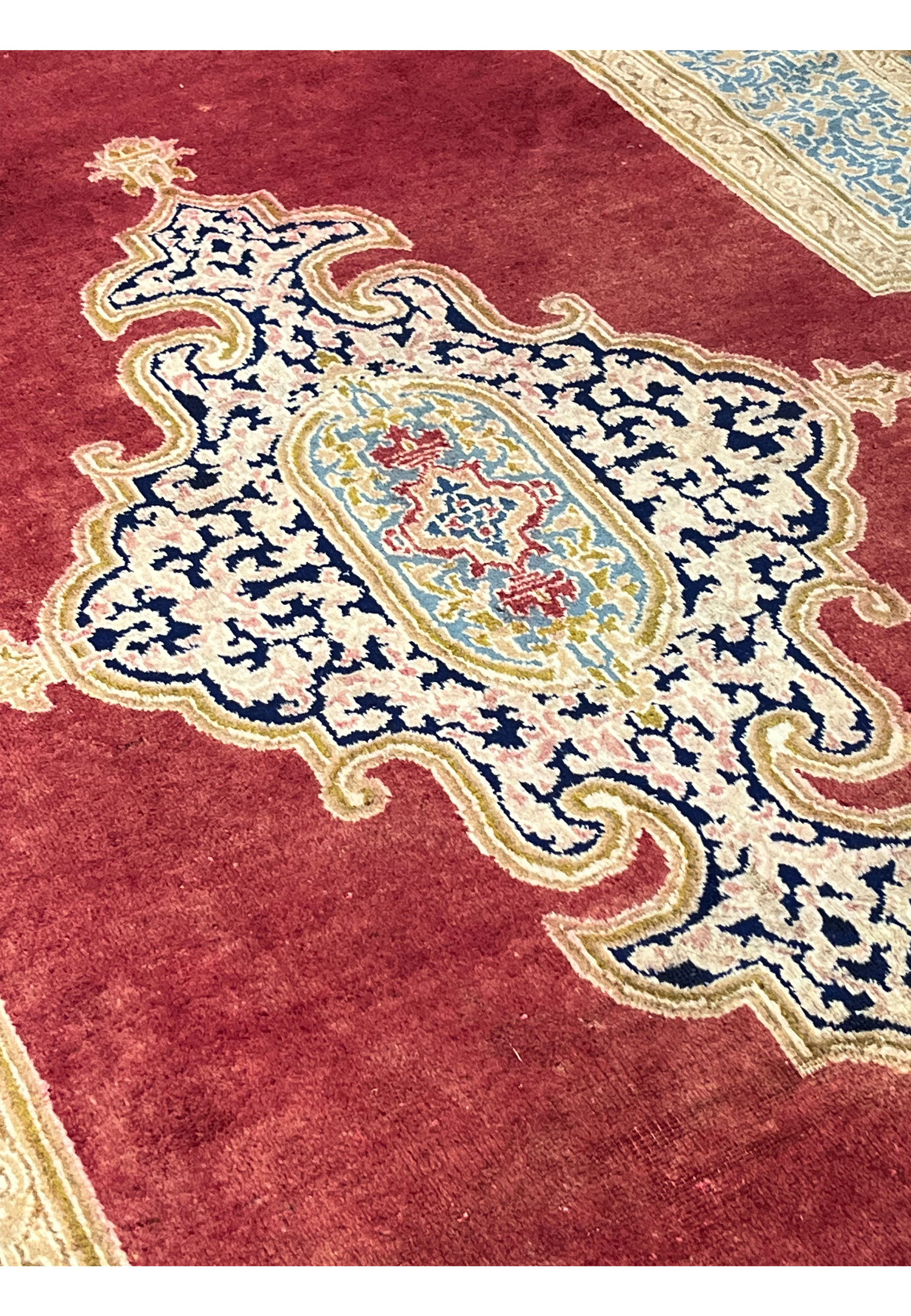 Side profile of handmade Persian Kerman rug displaying medium wool pile height, dense knots and crisp border definition