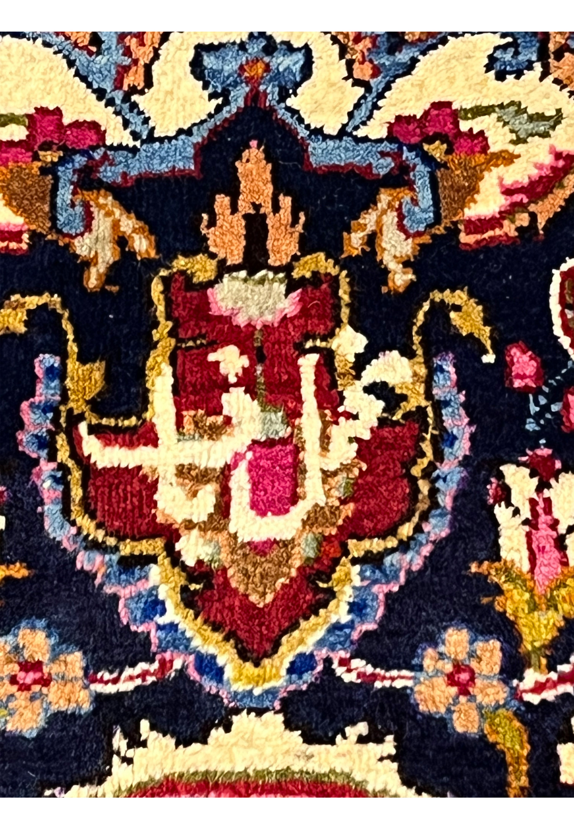 Detail view of the woven signature on signed Persian Mashad Makhmal Baf rug, highlighting workshop mark, fine knotting, and authentic craftsmanship.