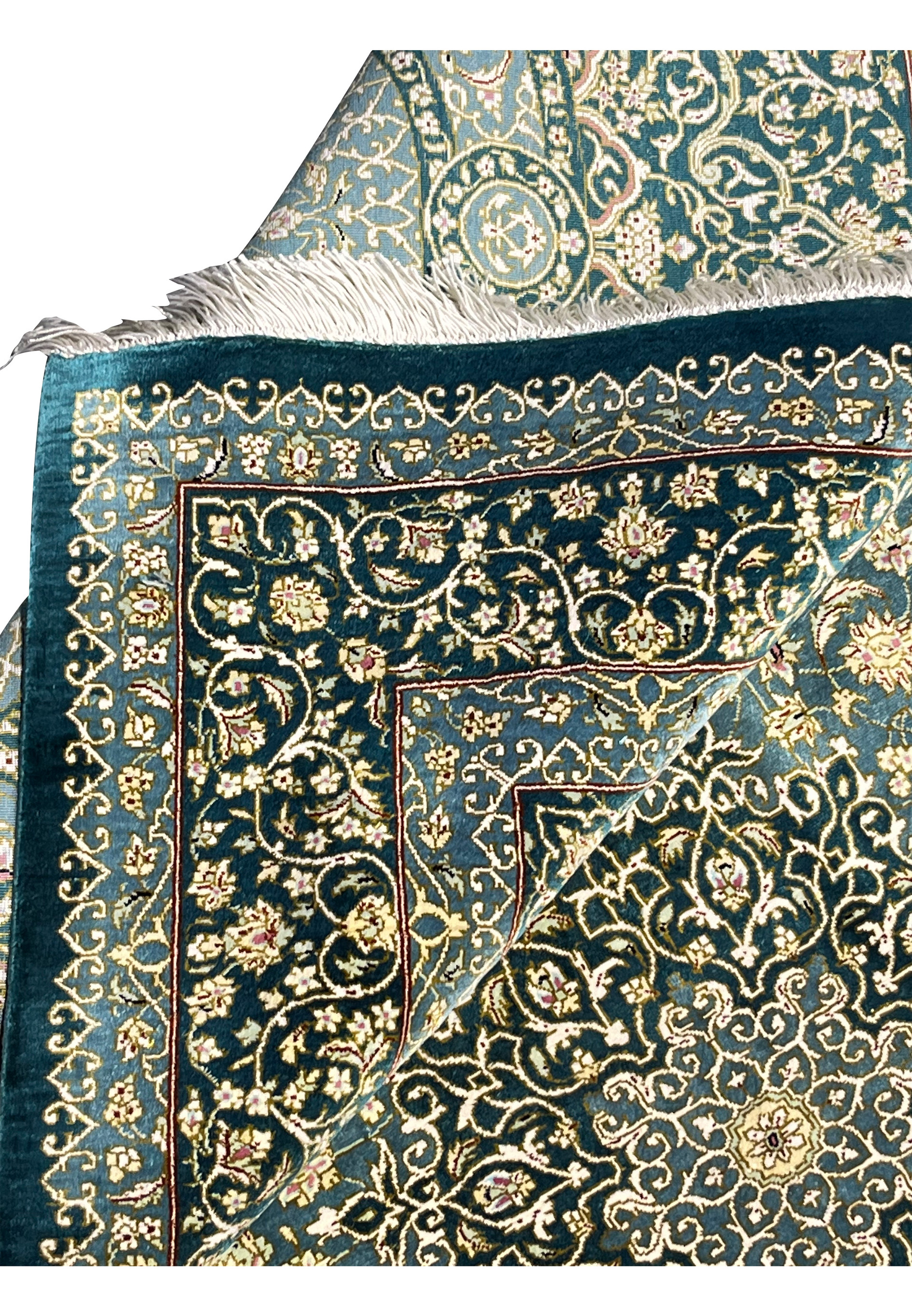 Folded edge detail of silk handmade rug showing clean backing, tight knots and crisp floral pattern alignment along border