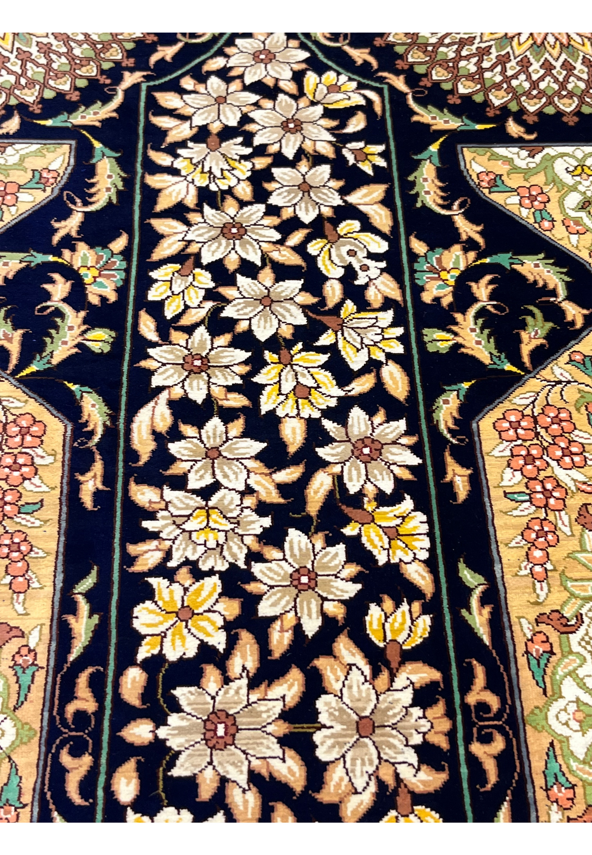 All-over botanical pattern featuring symmetrical panels, arabesques and rosettes in ivory, beige and olive tones on midnight blue silk field