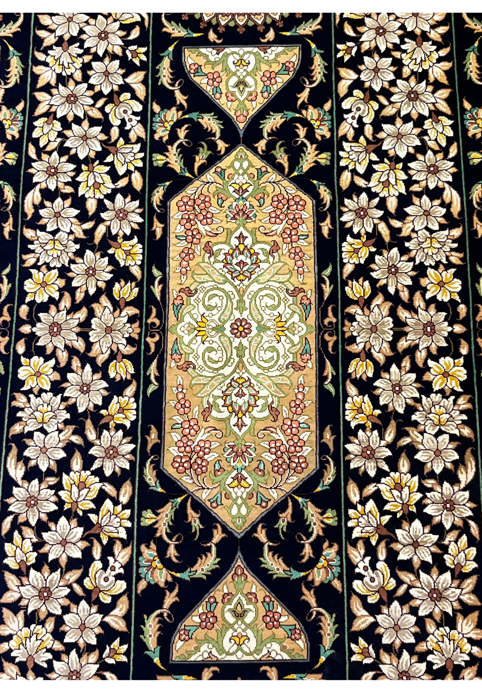 Persian Qum silk rug close-up of intricate starburst medallion with navy field, ivory florals, gold outlines and fine 1000 KPSI knot detail