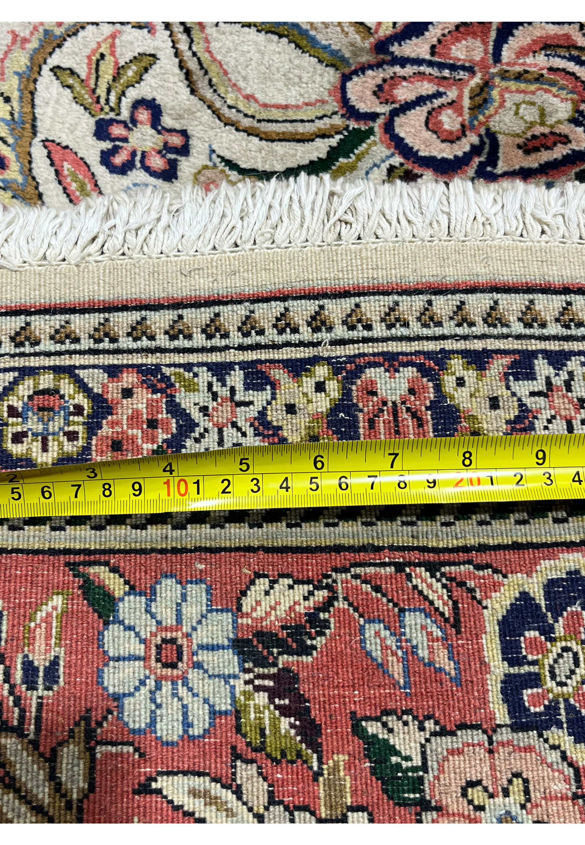 Back of 7x10 Persian Bijar rug with ruler illustrating dense construction cotton foundation and firm weave