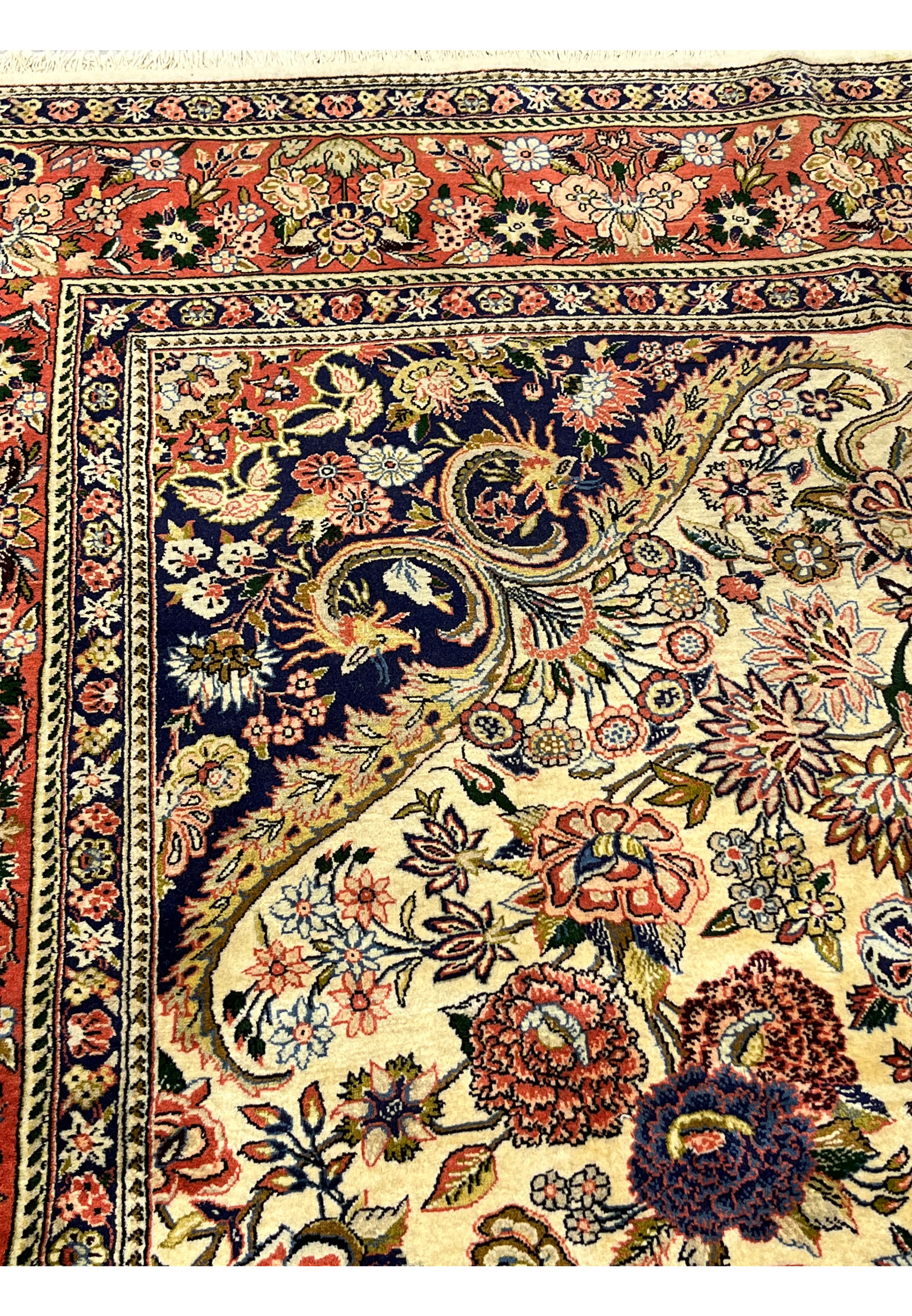 Inner navy border detail on Persian Bijar rug with repeating floral motifs ivory outlines and fine precision