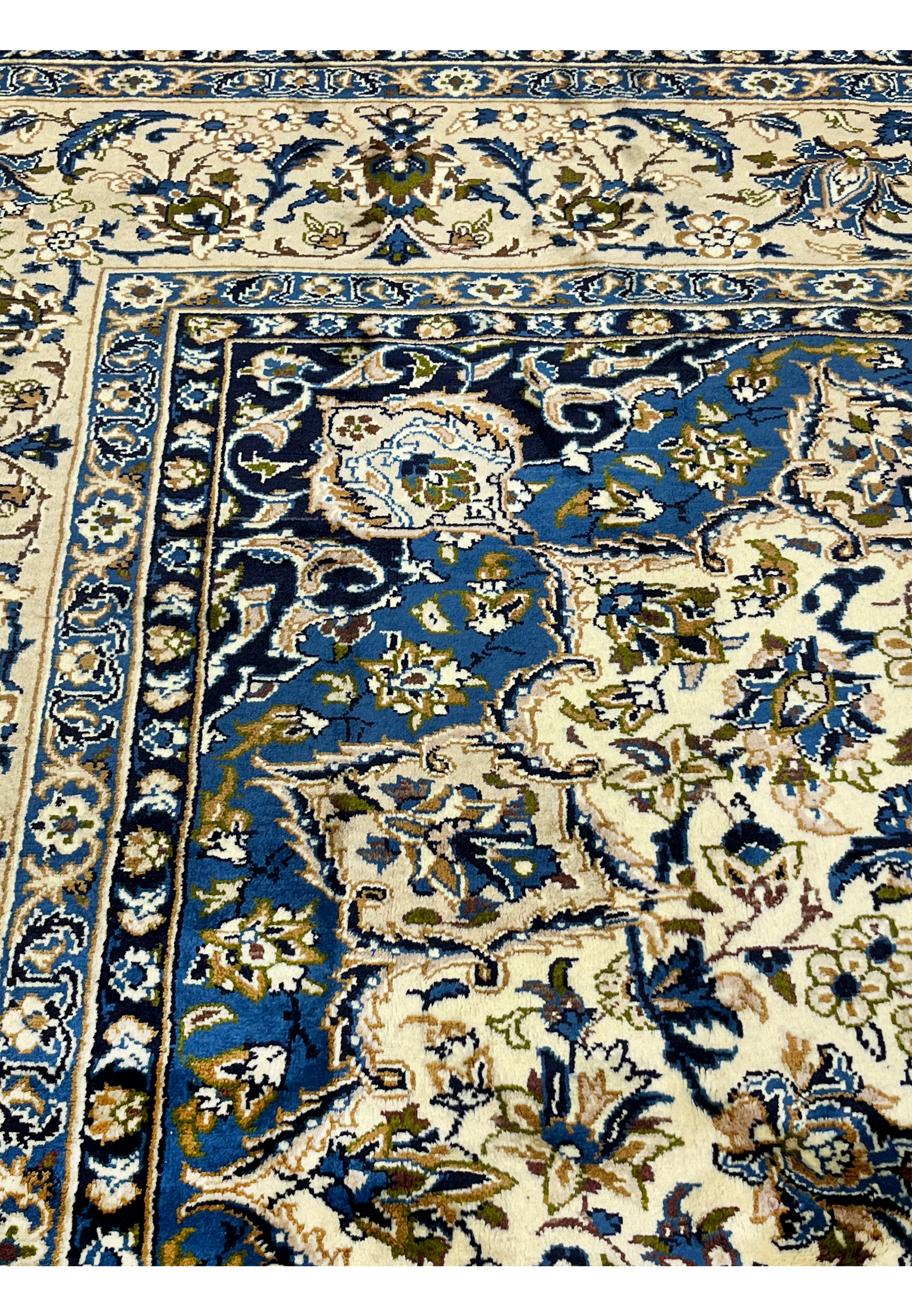 10'2 x 14'3 Persian Kashan rug inner border closeup showing navy floral guard stripes ivory ground intricate vine details and fine wool weave