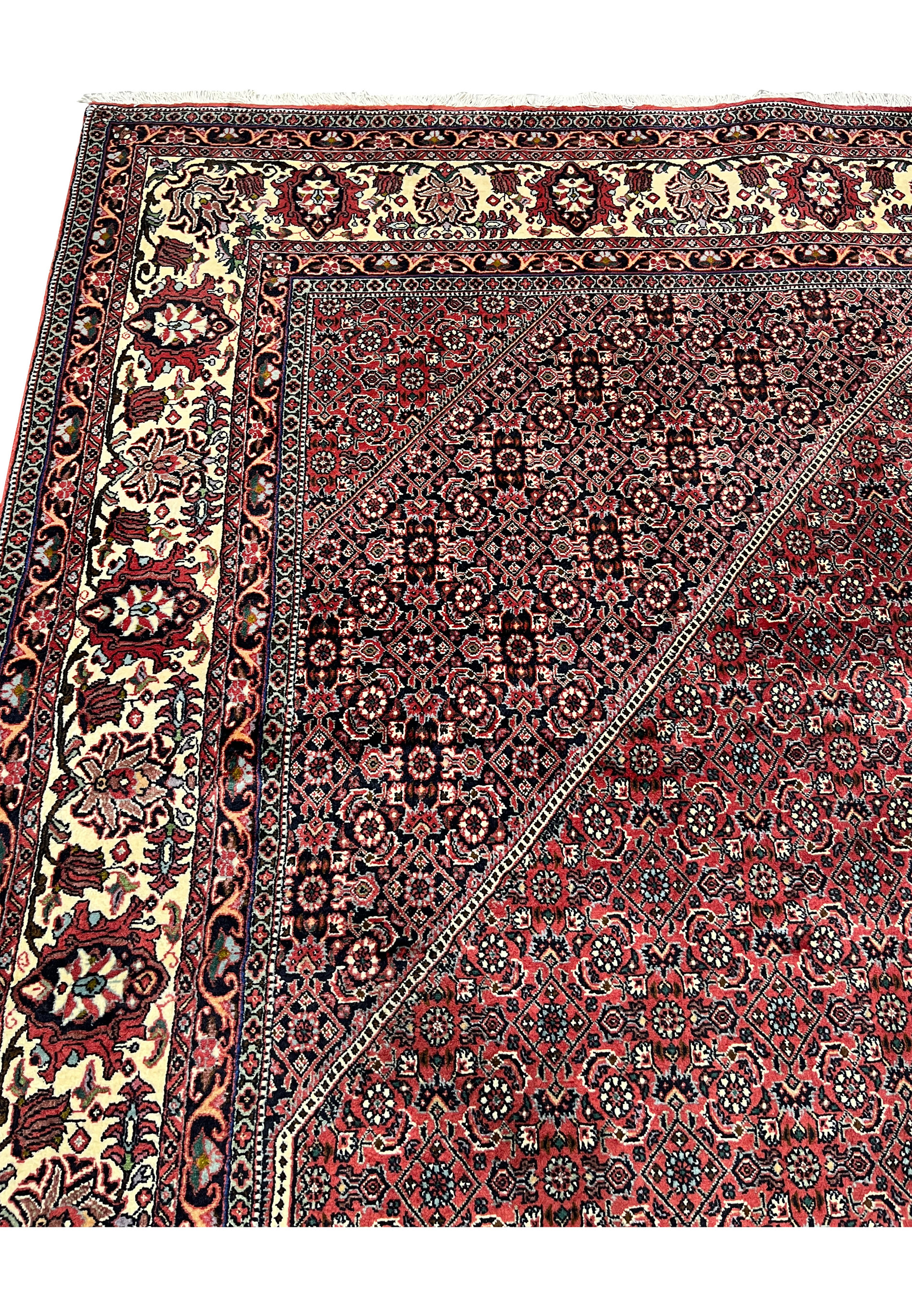 Upper border detail of 8'2 x 11'4 Persian Bijar Iron Rug in deep red and ivory with traditional floral guard borders and strong outlines