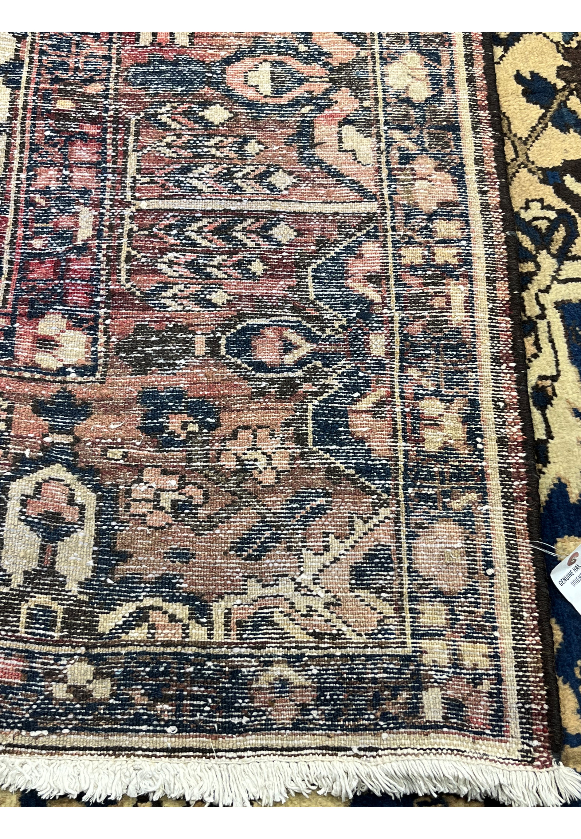 Backside view of 11x13'3 Vintage Persian Heriz rug showing tight hand knotted construction, navy and ivory pattern clarity