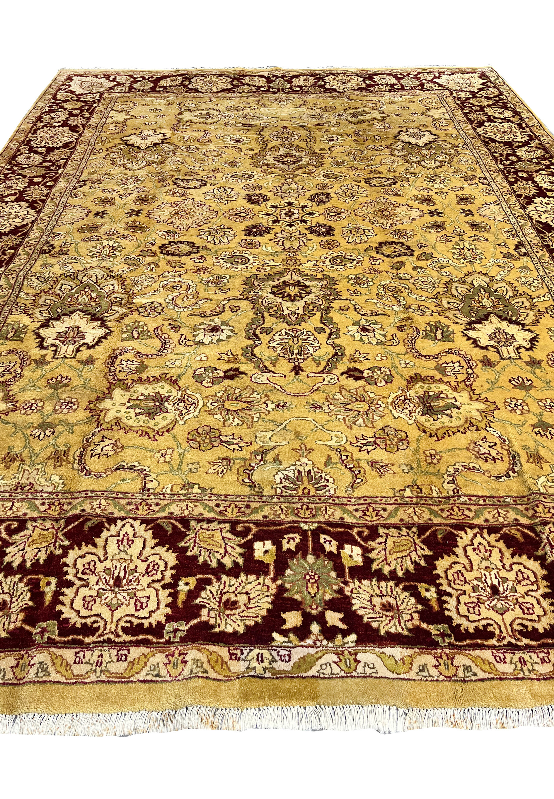 Front view of 9x12 antique gold Agra rug laid flat showing symmetrical floral design.