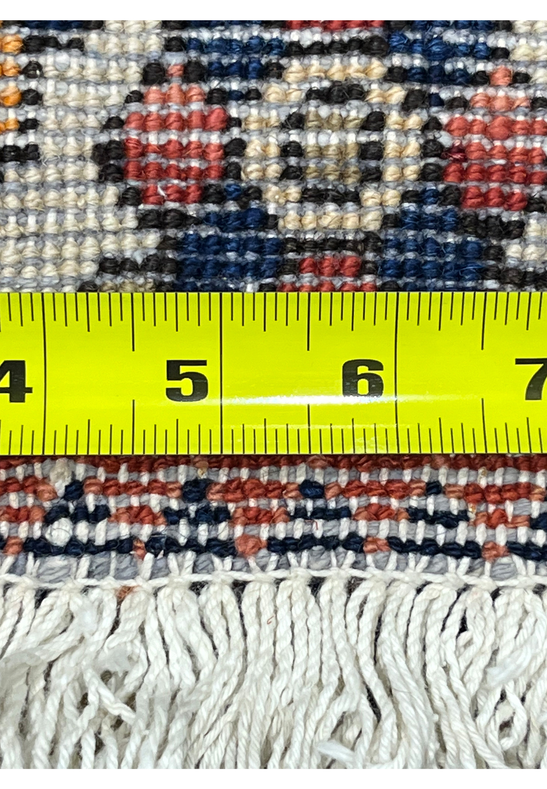 Back of vintage Persian Bakhtiari rug showing hand-knotted cotton foundation and tight knot structure