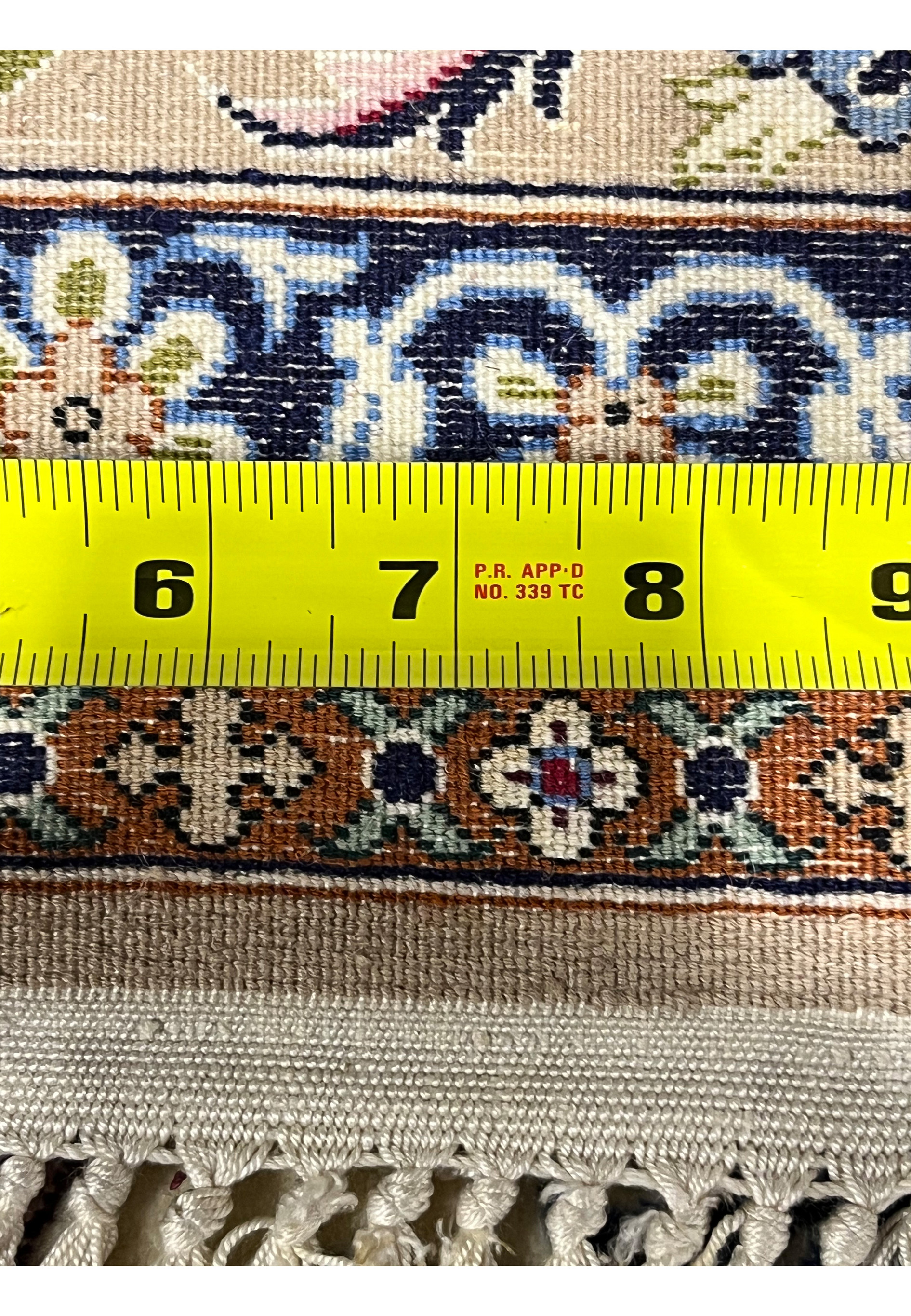 Backside with ruler Persian Isfahan wool silk rug measuring knot density hand knotted cotton foundation Darri