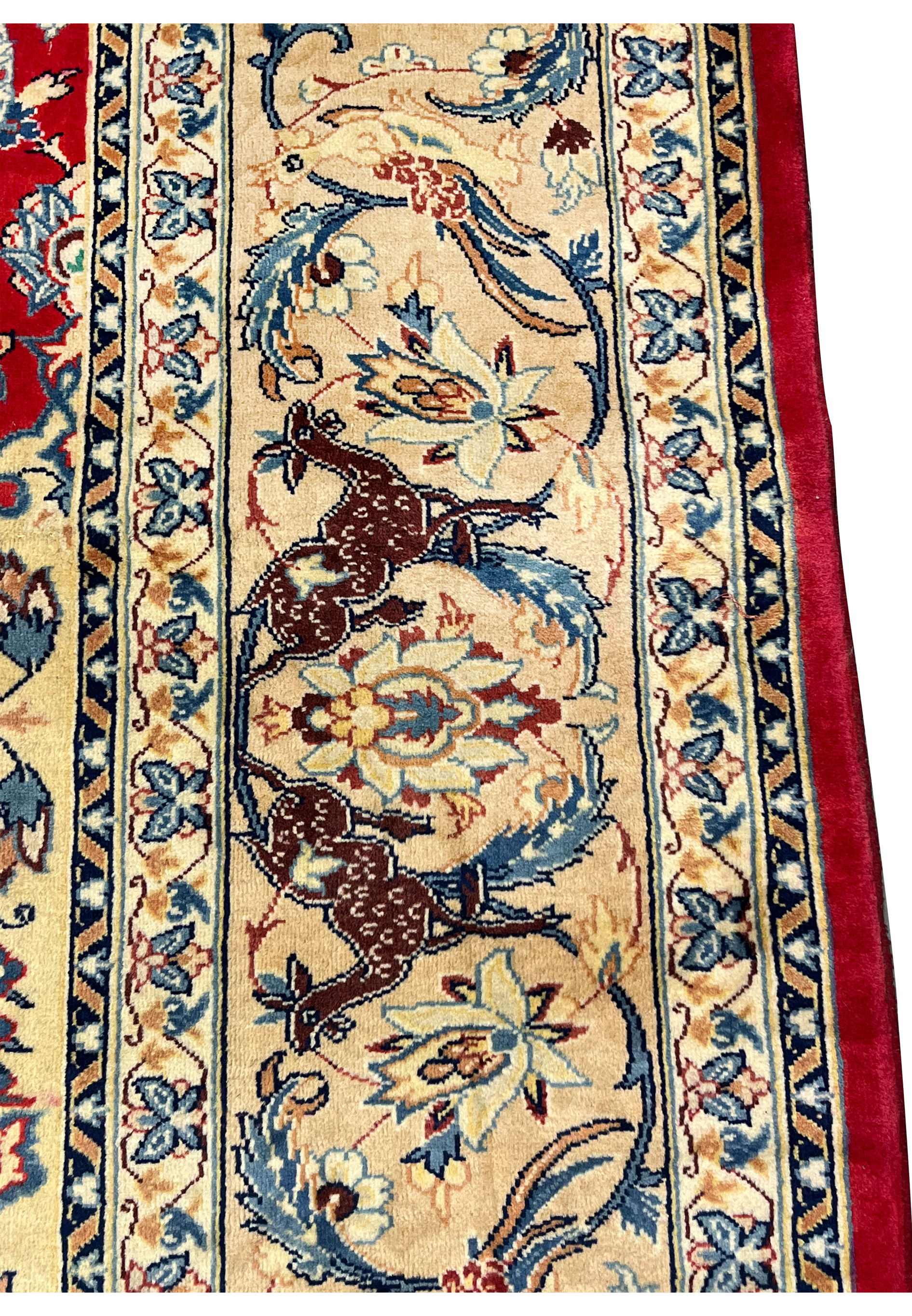Animal motif closeup 10x13 Persian Isfahan wool rug brown deer on ivory border blue floral surround crimson field