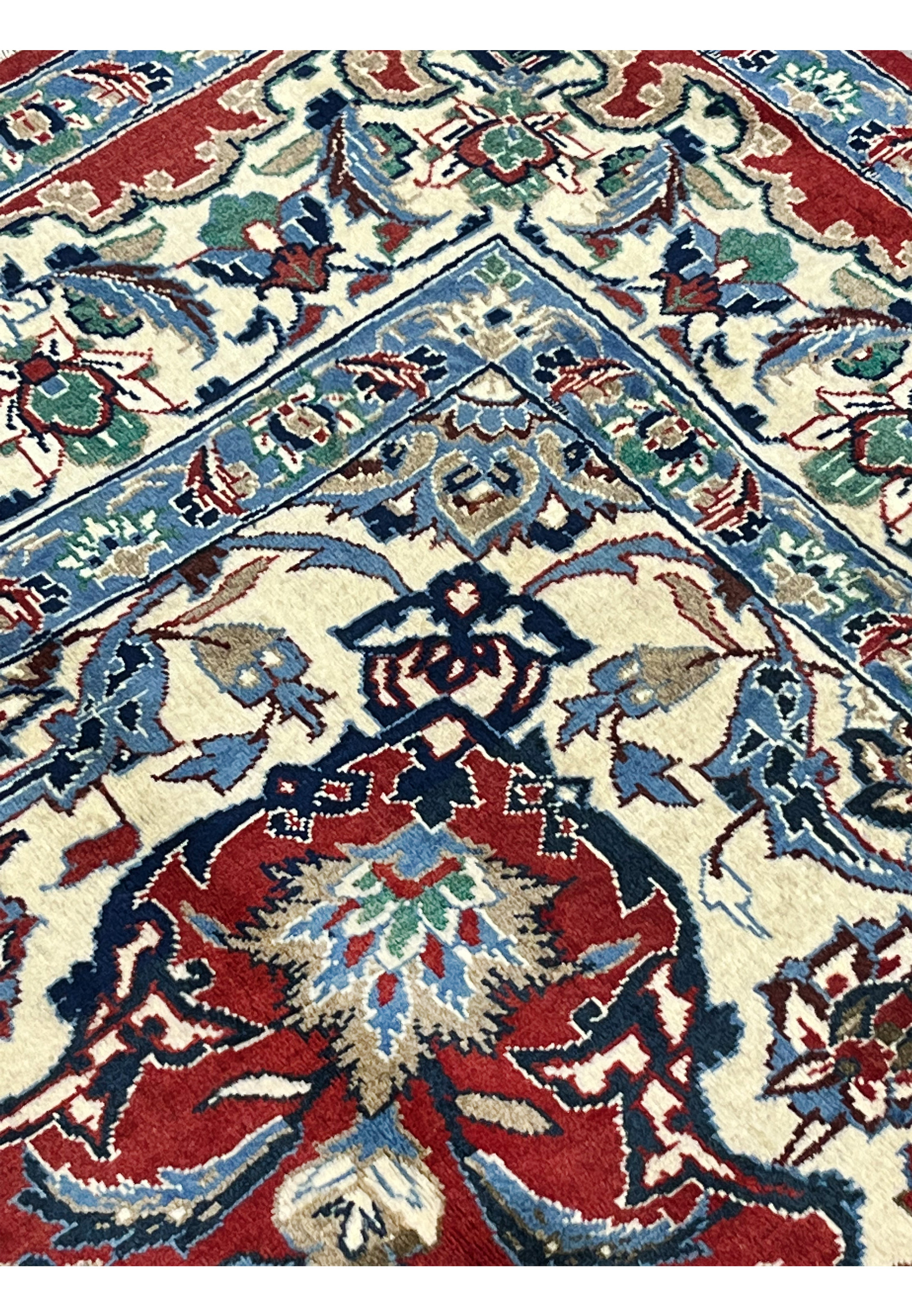 Inner border detail 8x12 Persian Isfahan wool rug ivory ground blue floral arabesque scrollwork crimson red field