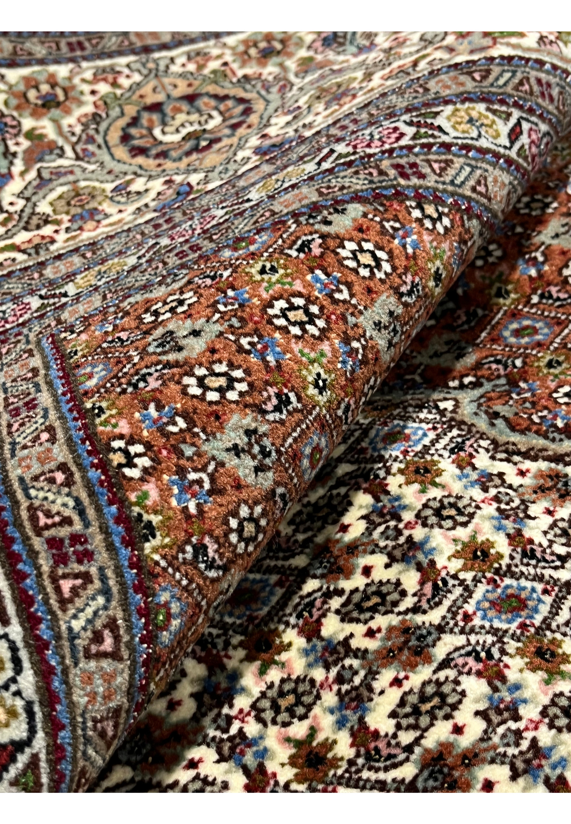 Rolled Persian Tabriz Mahi wool silk rug 50 Raj showing pile depth silk sheen herati fish pattern ivory brown field