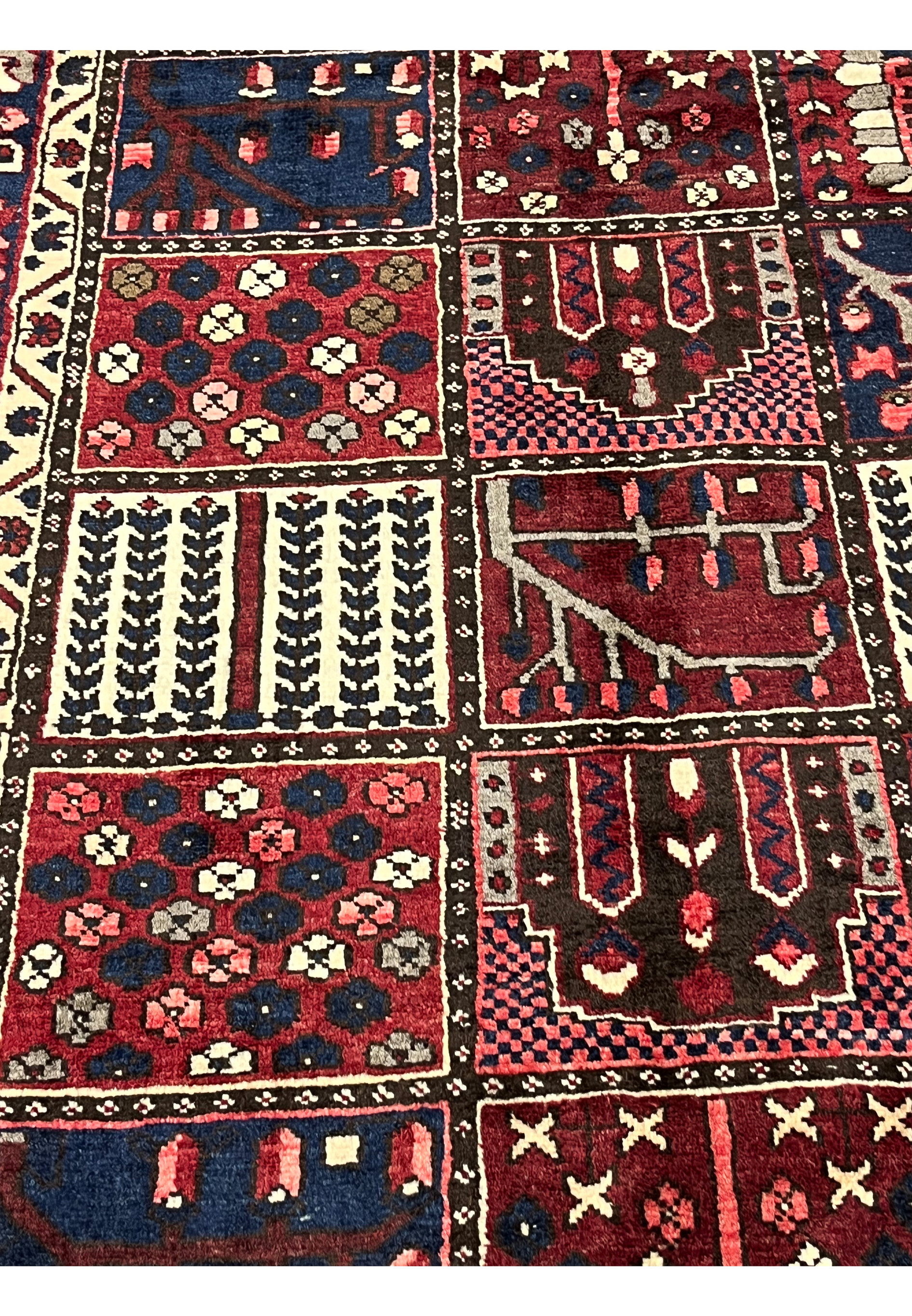 Close-up of hand-knotted khane compartments in 6'8x10 Persian Bakhtiari red and navy rug