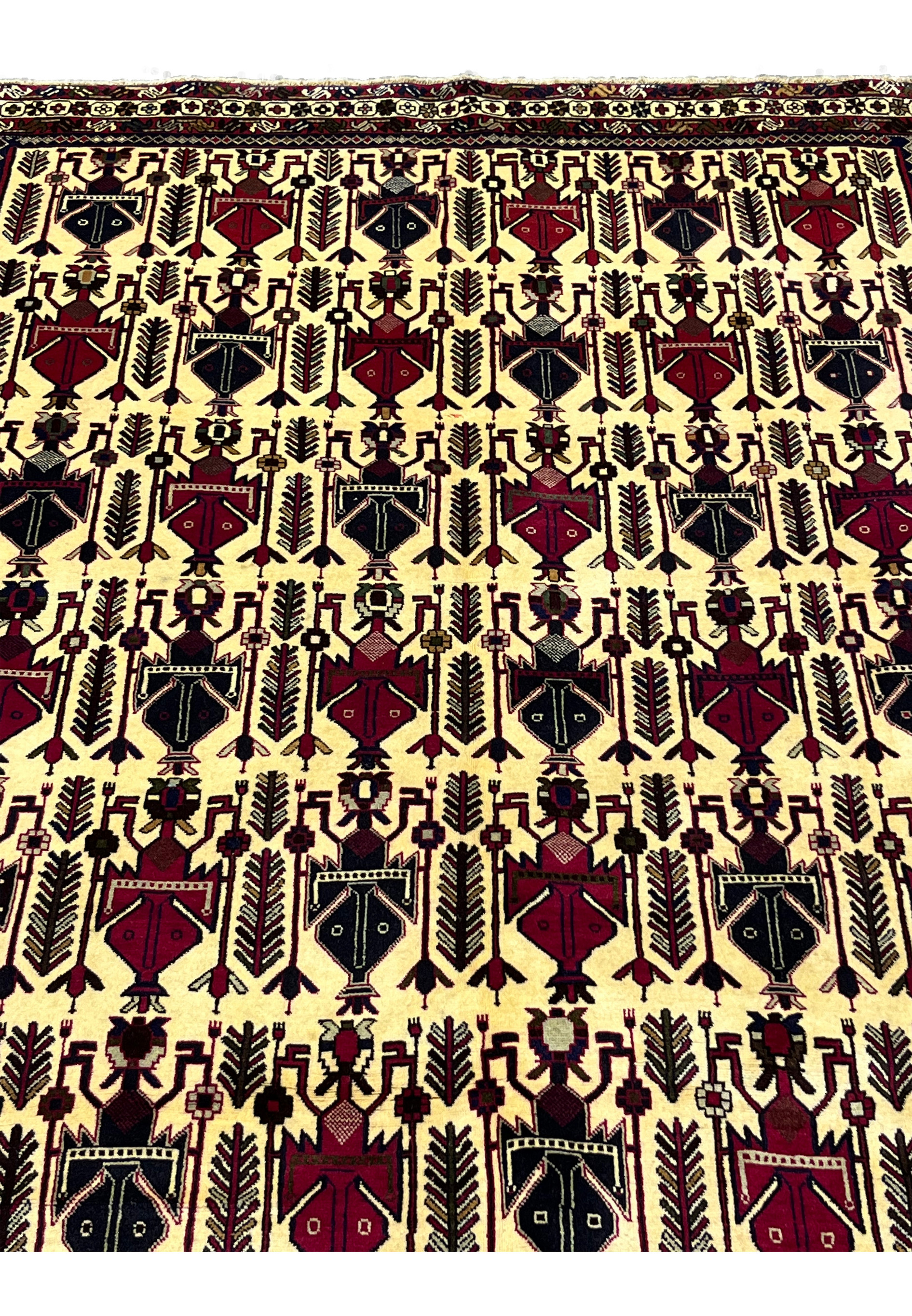 Close-up of tribal boteh motifs in 5x8 Persian Afshar wool rug on warm ivory ground