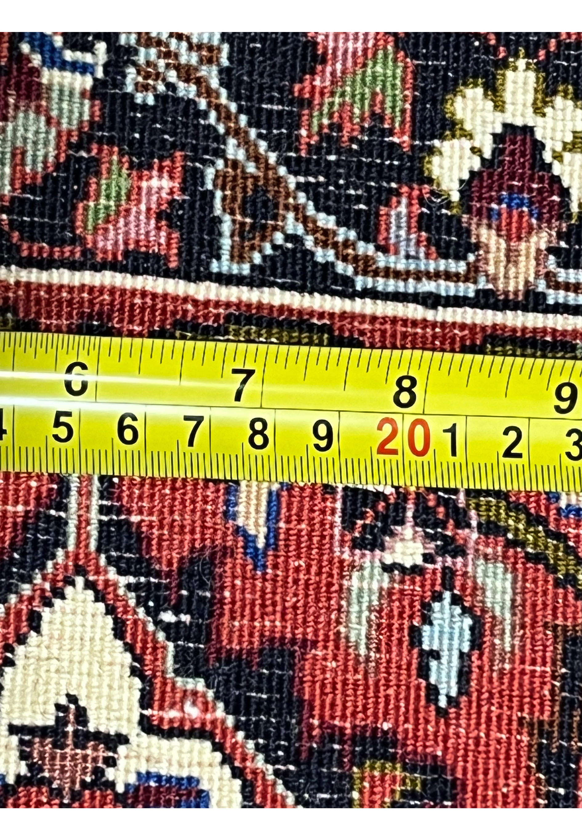Back of authentic Persian Bijar rug measured with ruler, showing dense hand-knotted density