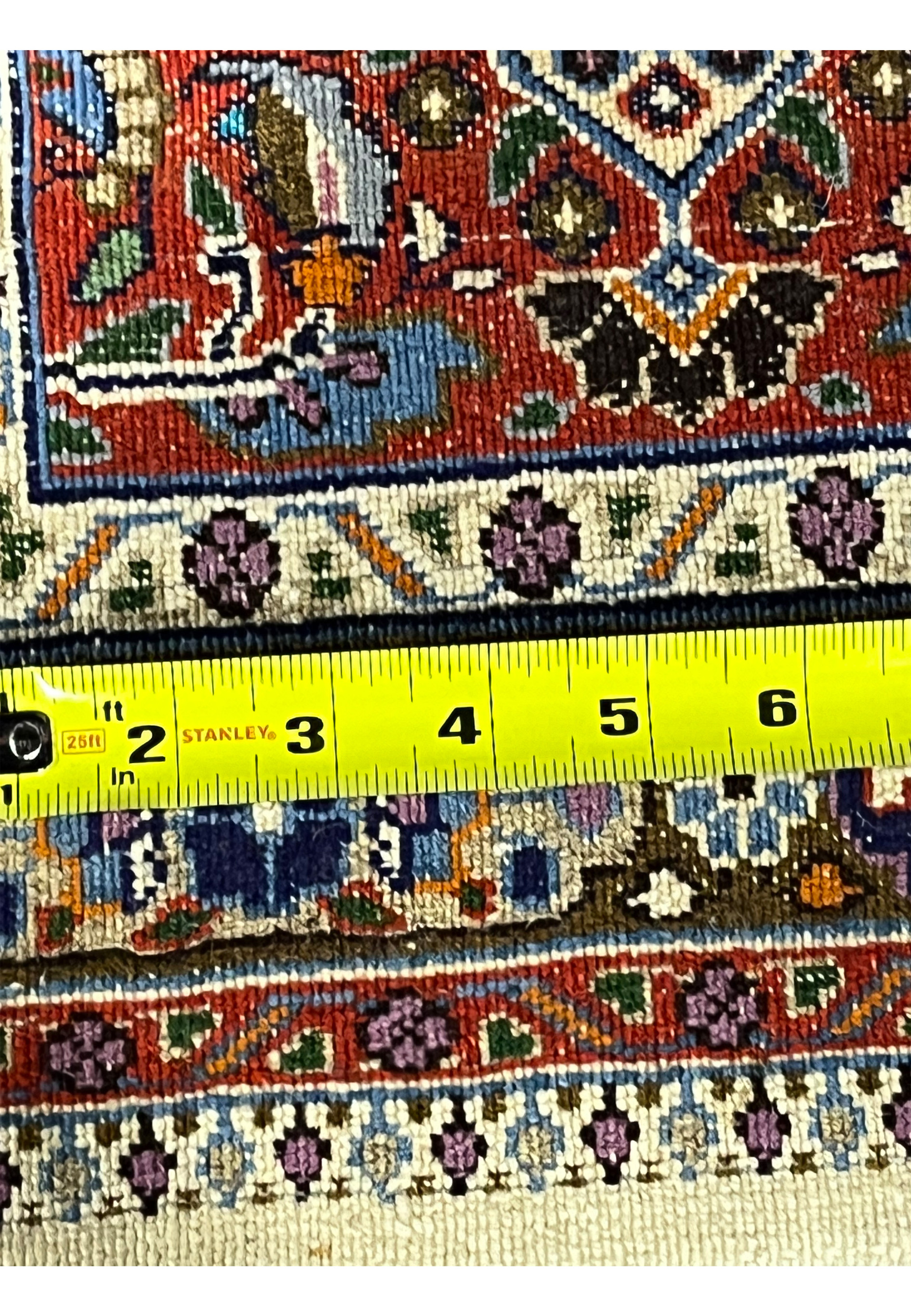 Back of authentic Persian Moud rug measured with ruler, showing dense hand-knotted density