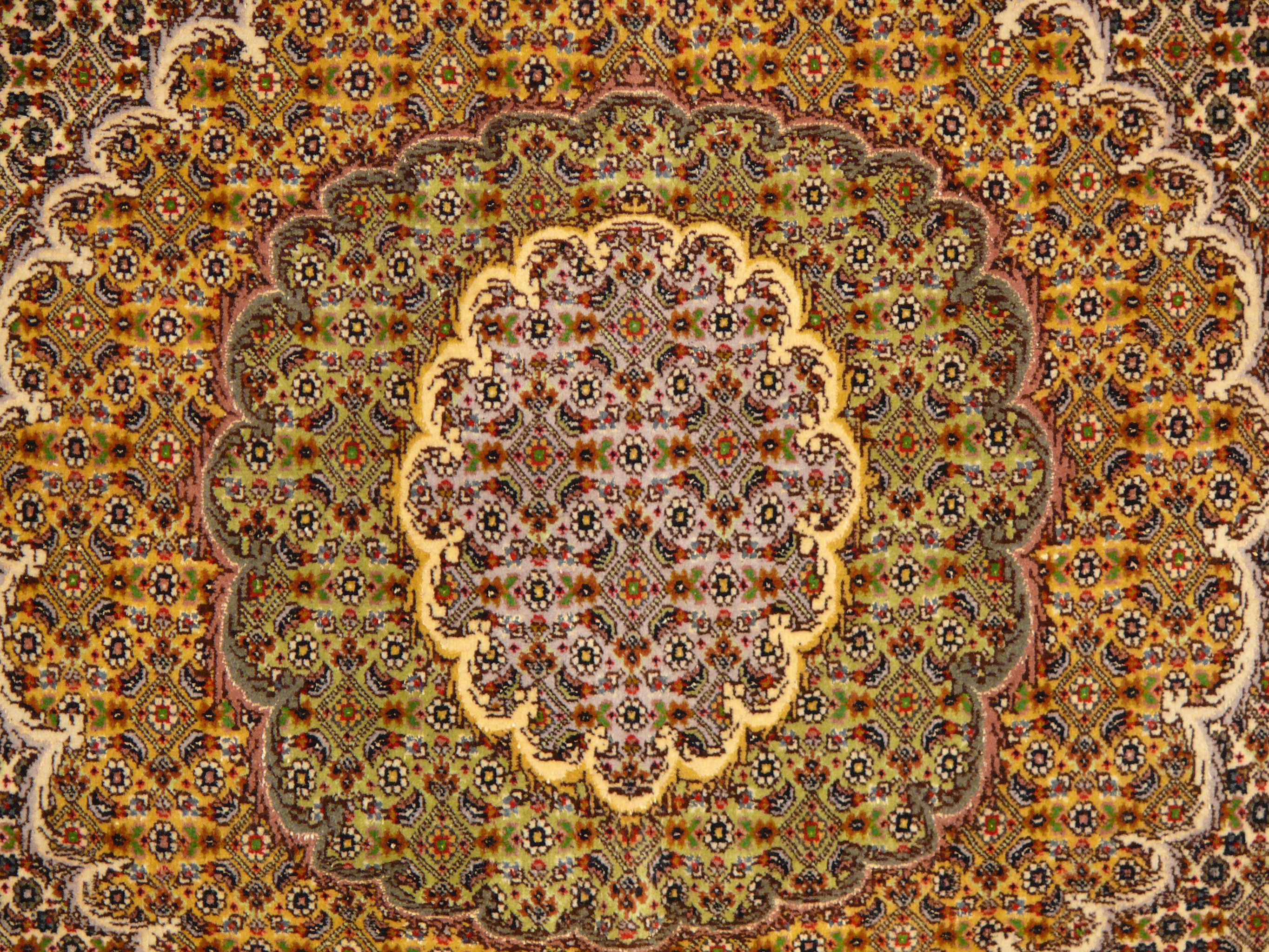 The predominantly beige color palette of our Persian Tabriz Rug with Mahi Design is accented with pops of blue for a touch of vibrancy