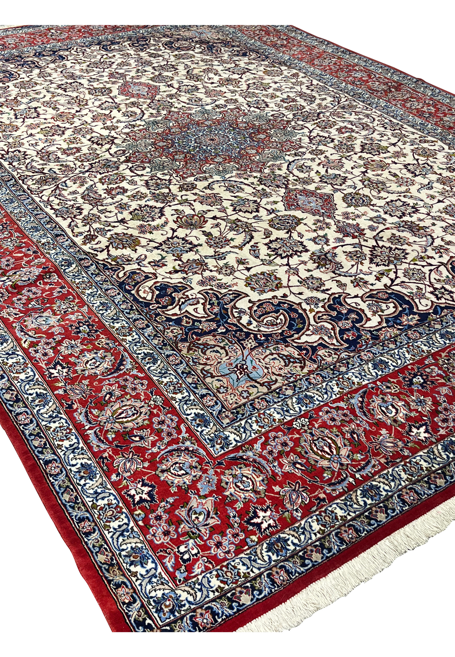 Angled view 8x12 premium Persian Isfahan wool silk rug ivory field crimson red border navy medallion handmade Persia