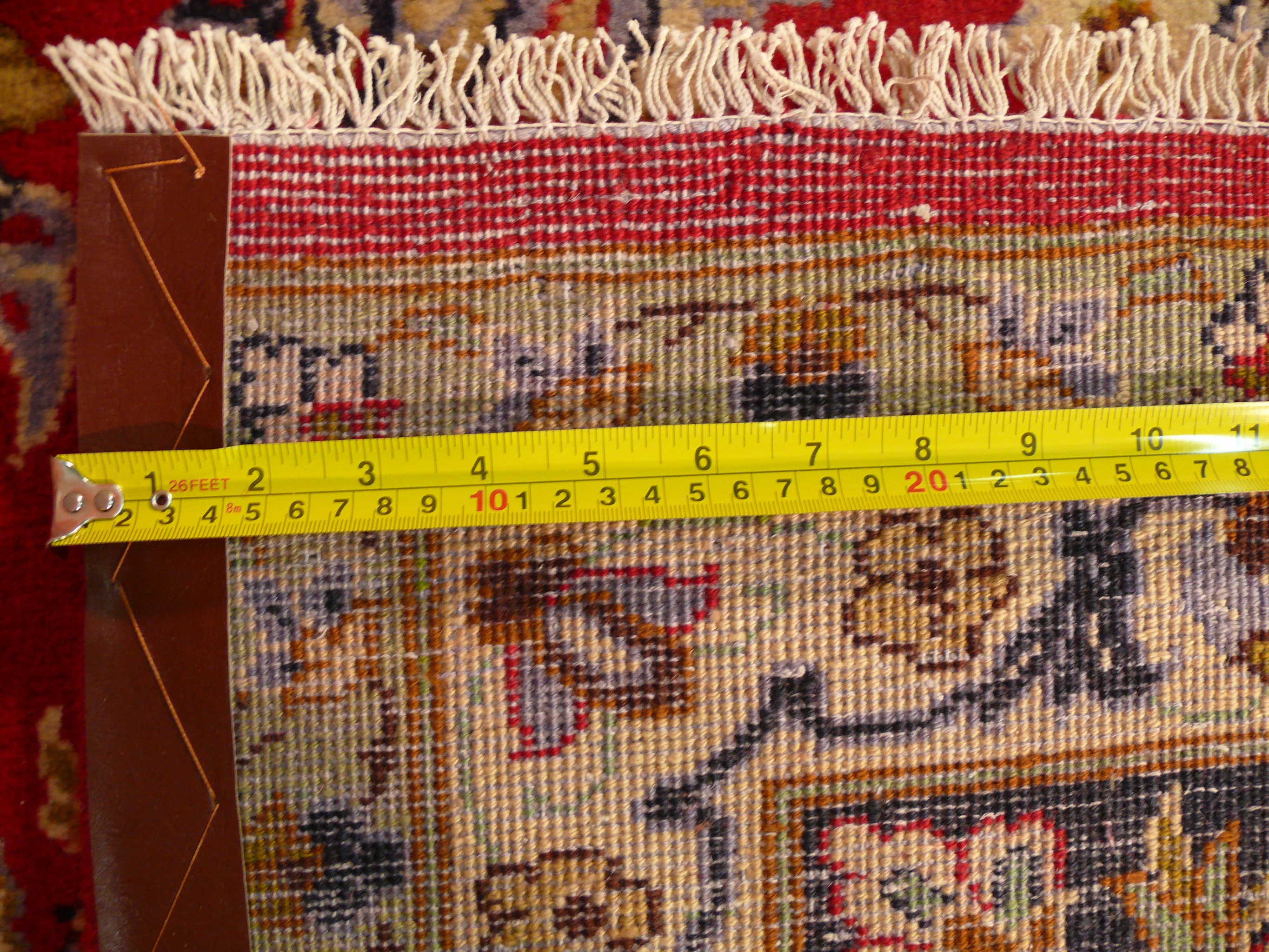 Backside of the rug with a ruler on it showing the dense weaving technique of this 10x13 Persian Isfahan Rug