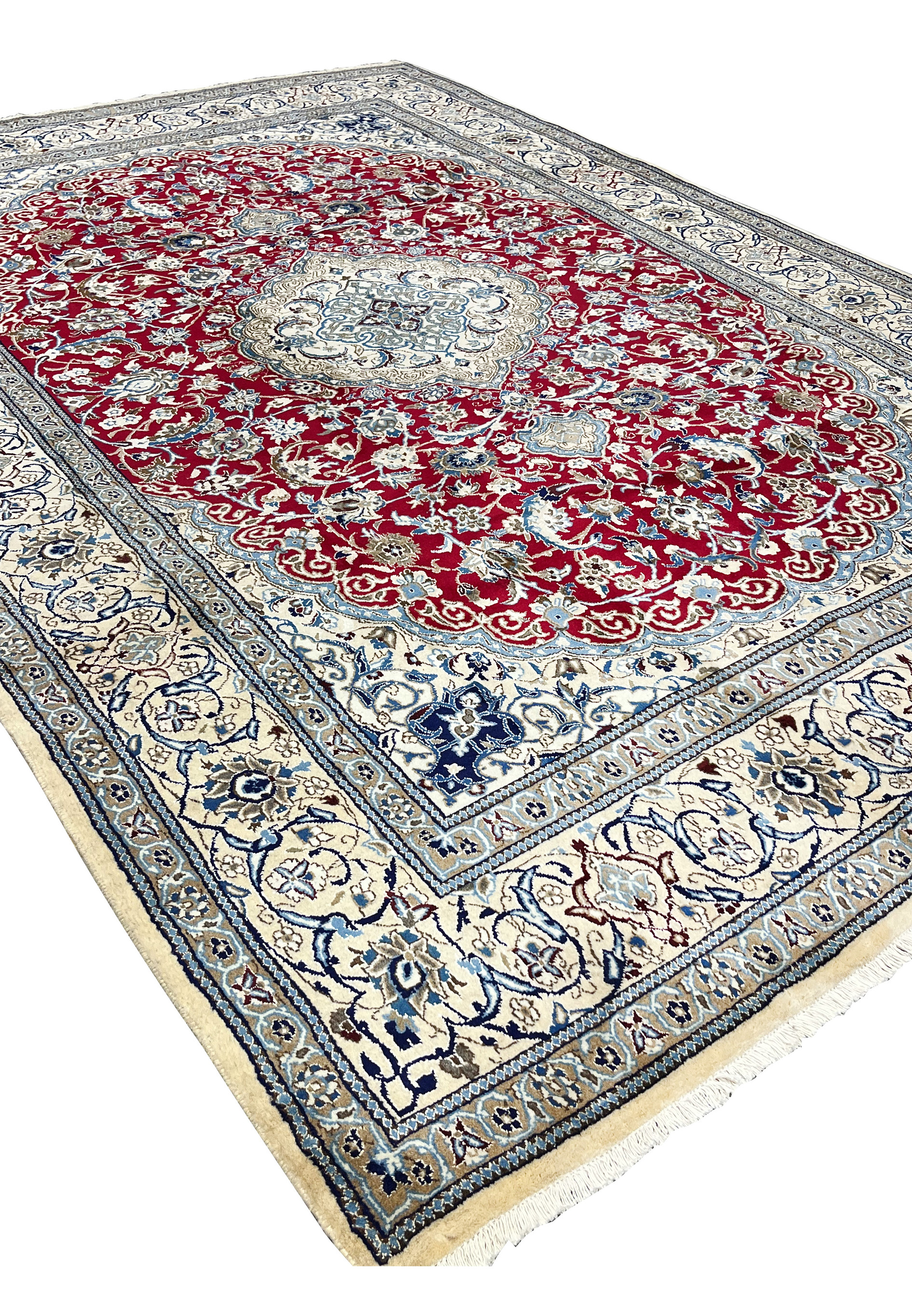 Angled perspective of red Persian Nain 9LA rug highlighting medallion depth, border framing, and surface texture