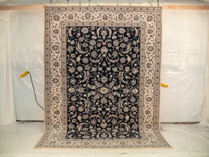 8x11 Nain Persian Wool and Silk Rug, hanging to show the complete rug.