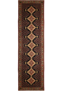 A close-up of a Persian Senneh runner featuring a geometric pattern in shades of blue, red, and ivory.