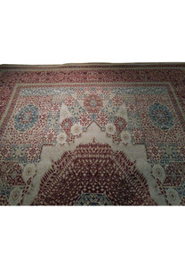 Partial view of a handmade Oriental Agra rug displaying the fine detail of its border and the contrasting cream and navy blue patterns.