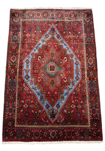 Perspective view of a Persian Gholtogh Rug, showing the detailed patterns that extend across its entire surface