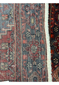 Detail shot of the fringe and back weave structure of a vintage 4x5 Persian Bijar rug, displaying the craftsmanship and the red and blue color palette
